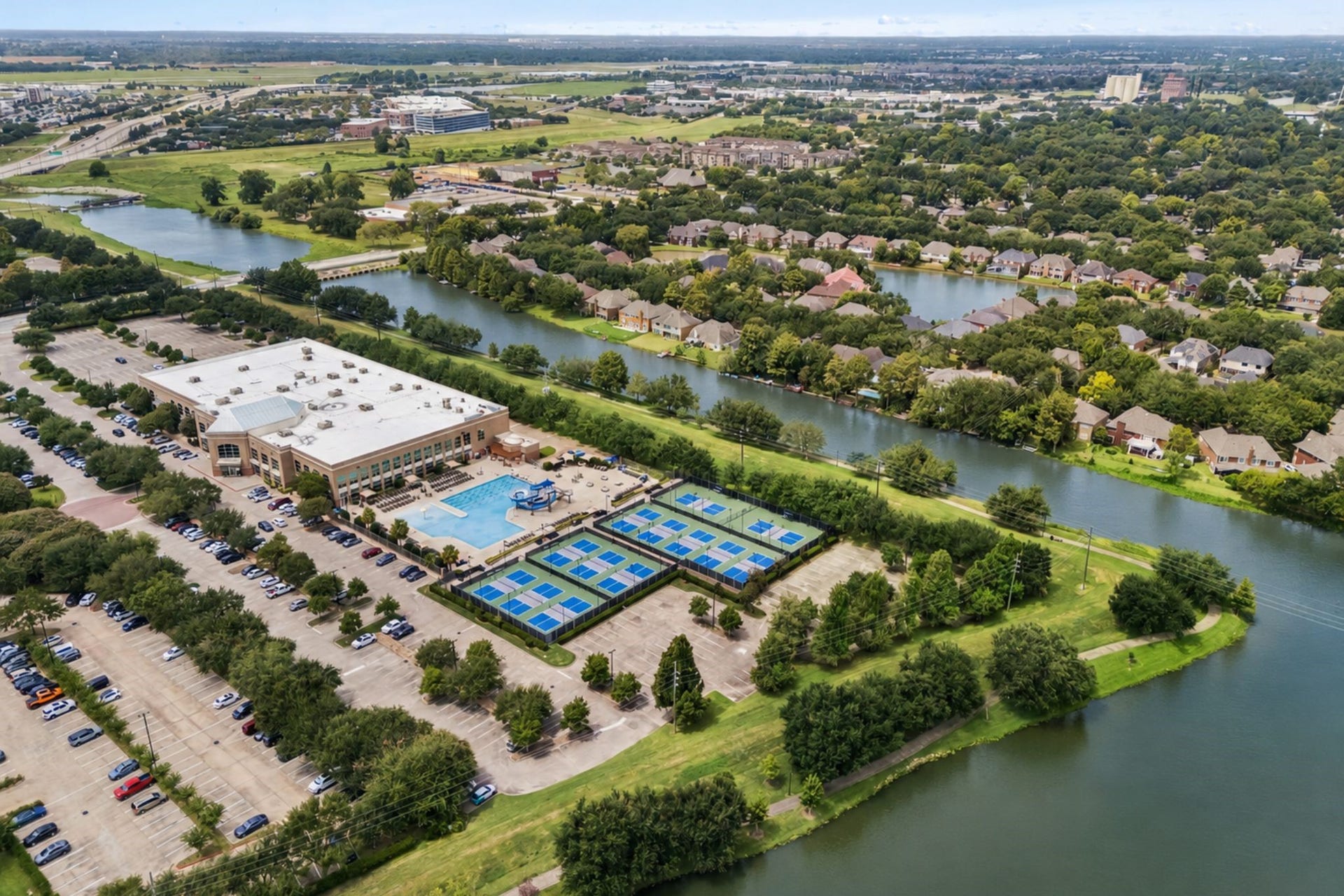 114 CAMELLIA STREET, Sugar Land, TX 77478 AERIAL VIEW HIGHLIGHTS THE HOMES ESTABLISHED SUGAR LAND SETTING, SURROUNDED BY MATURE TREES AND CONVENIENT CITY ACCESS.