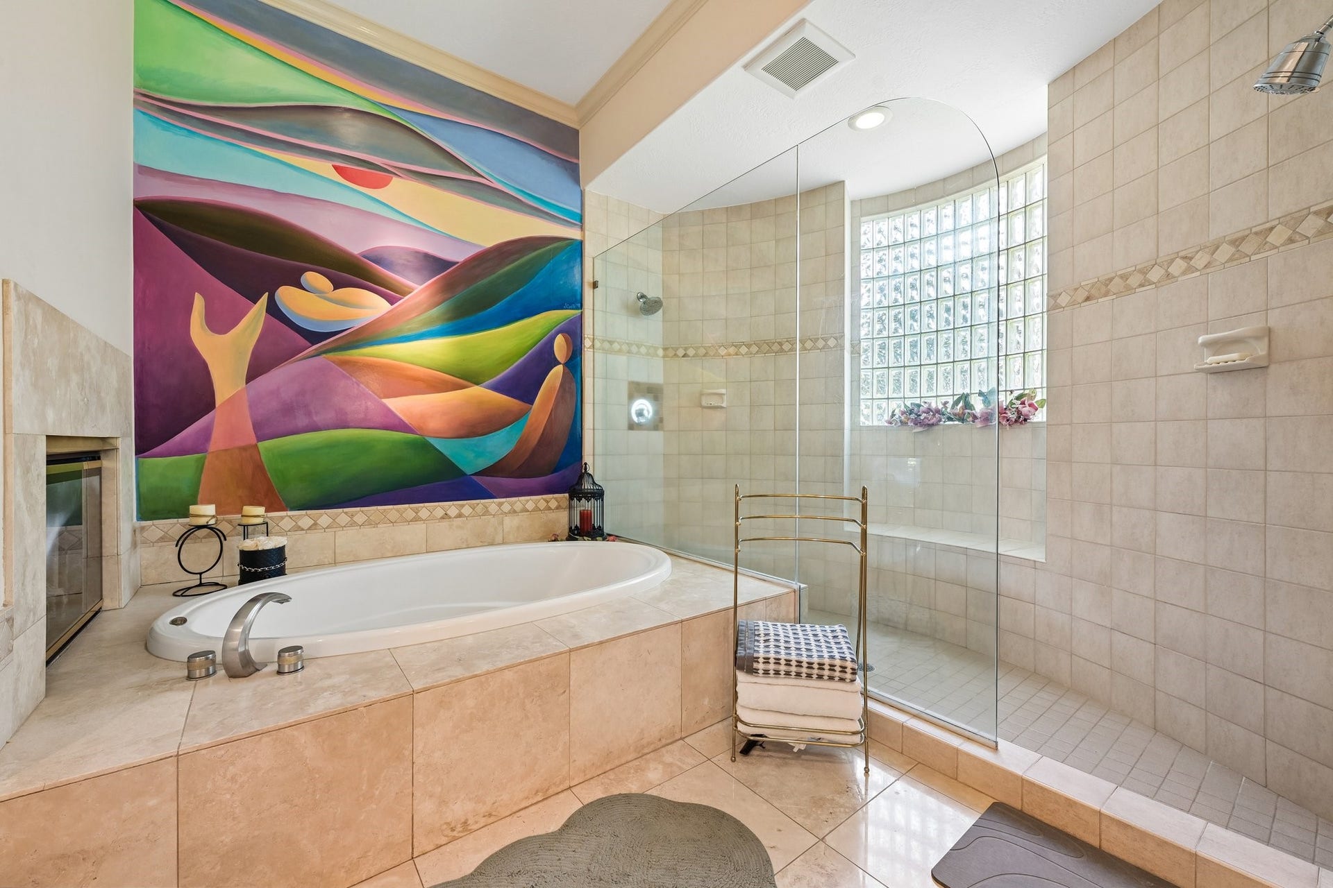 Relaxing primary bath retreat featuring a built-in soaking tub, and glass-enclosed walk-in shower with dual shower heads
