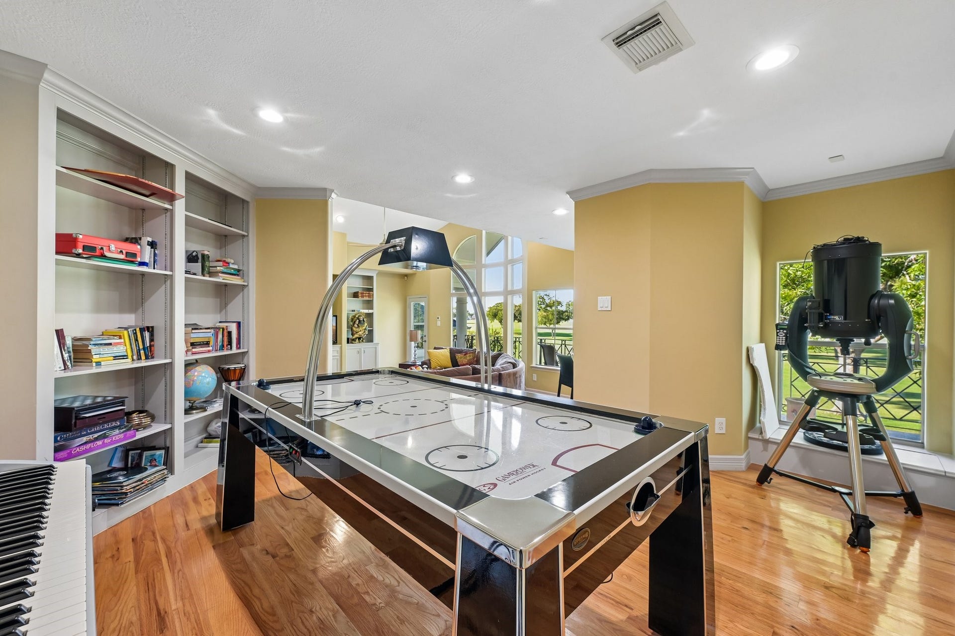 Dedicated game area featuring a built-in bookcase and endless possibilities for recreation, hobbies, or a personalized flex space