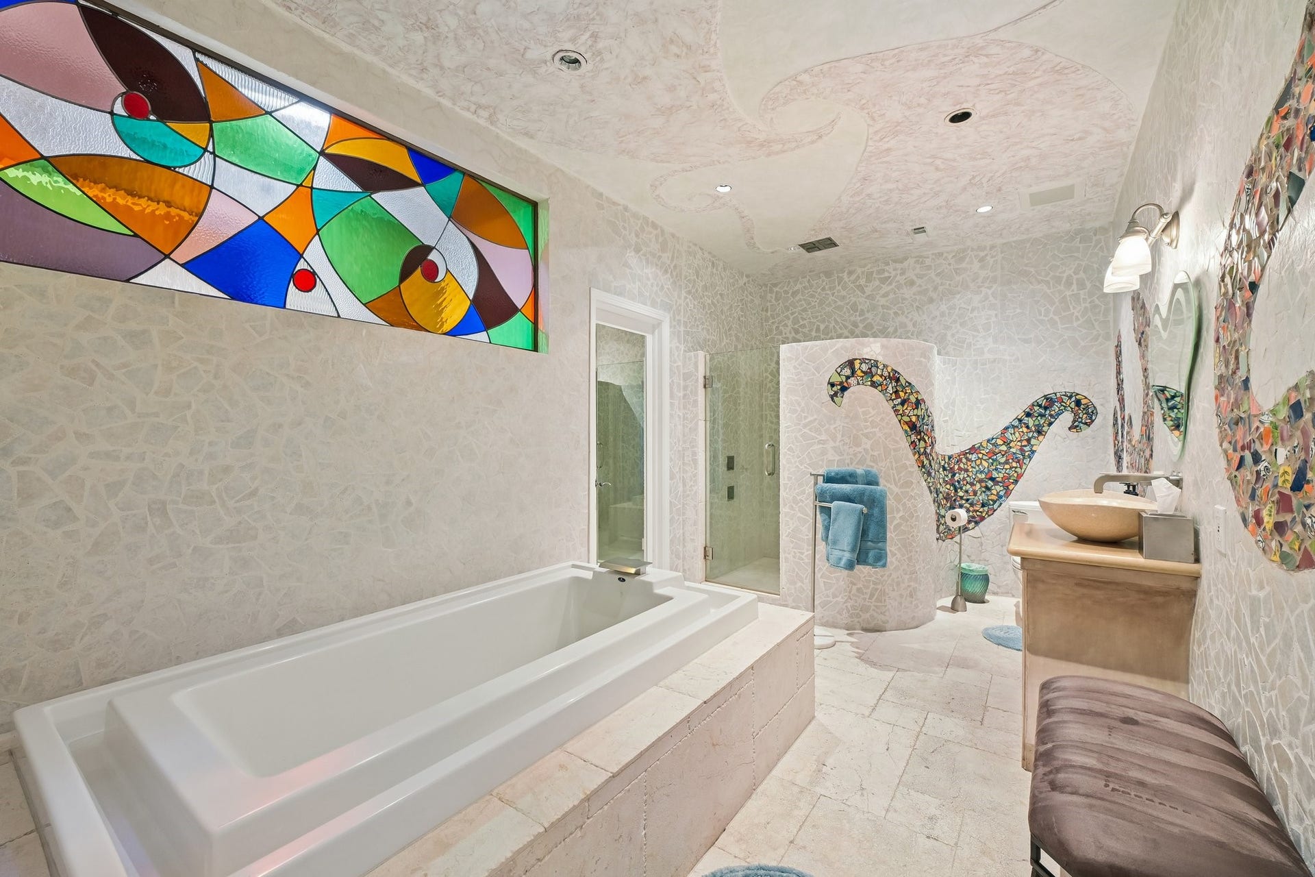 Completely remodeled secondary bathroom featuring striking mosaic tile accents, a spacious walk-in shower, and a built-in soaking tub