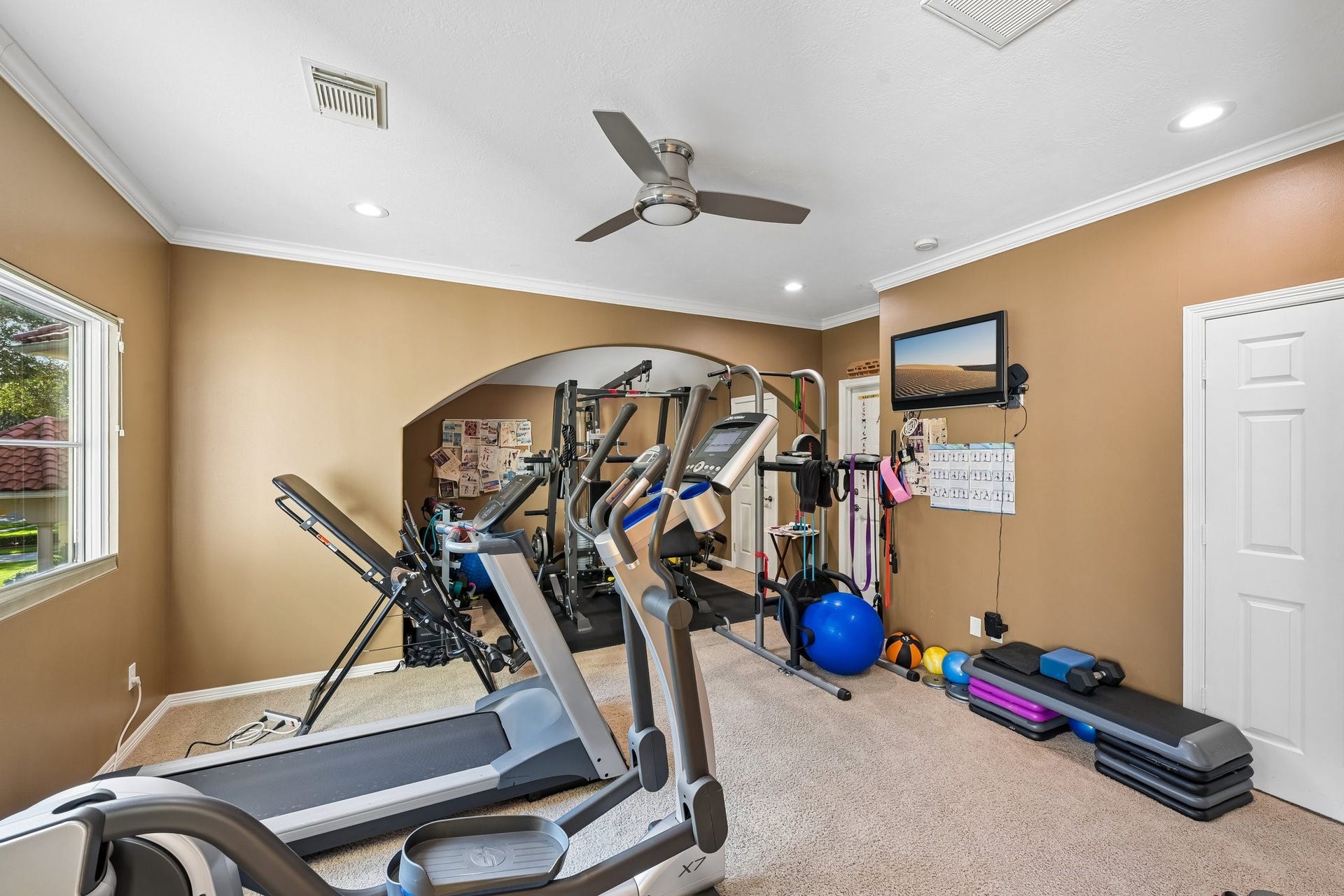 Dedicated fitness area featuring space for exercise equipment, with flexible potential to transform into a media room, hobby space, or customized retreat to suit the next owner's needs