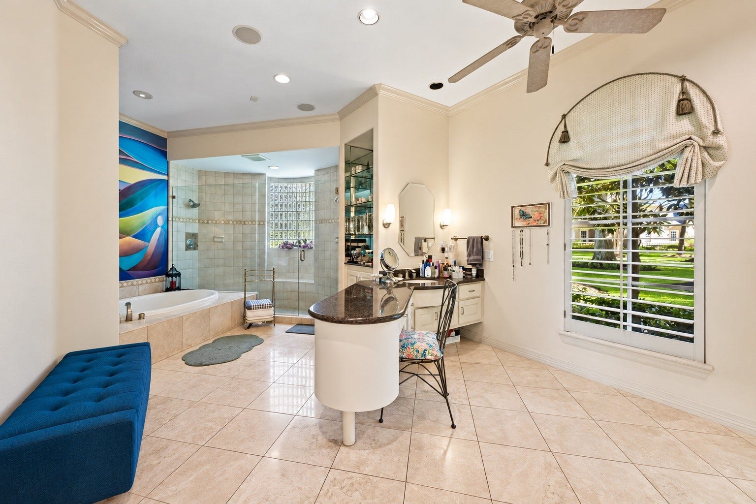 Spacious primary bathroom featuring an expansive vanity area, soaking tub, walk-in shower, and elegant finishes throughout
