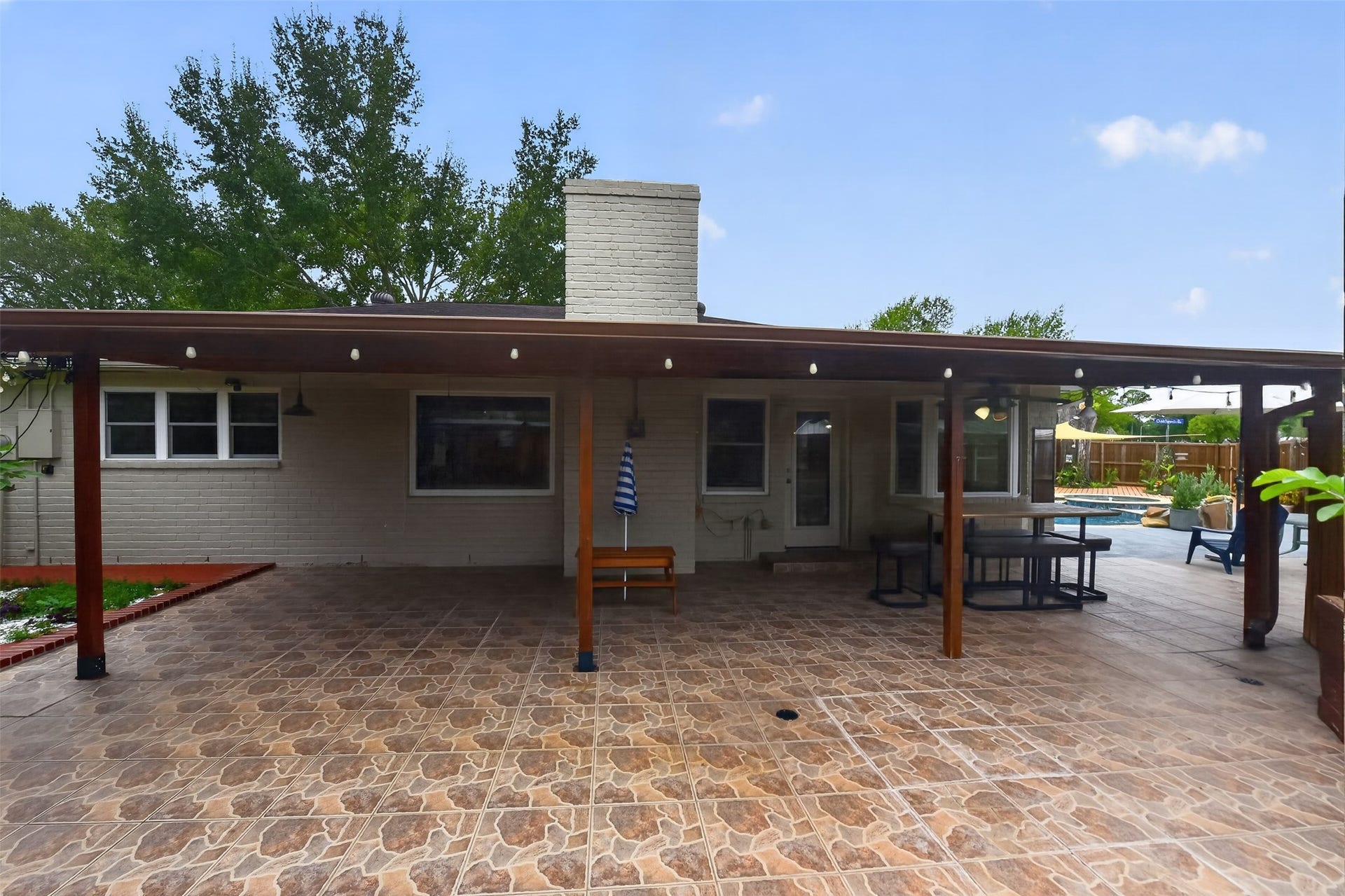 1918 Oaklawn Street, Sugar Land, TX 77498 View of covered patio and pool from the back.