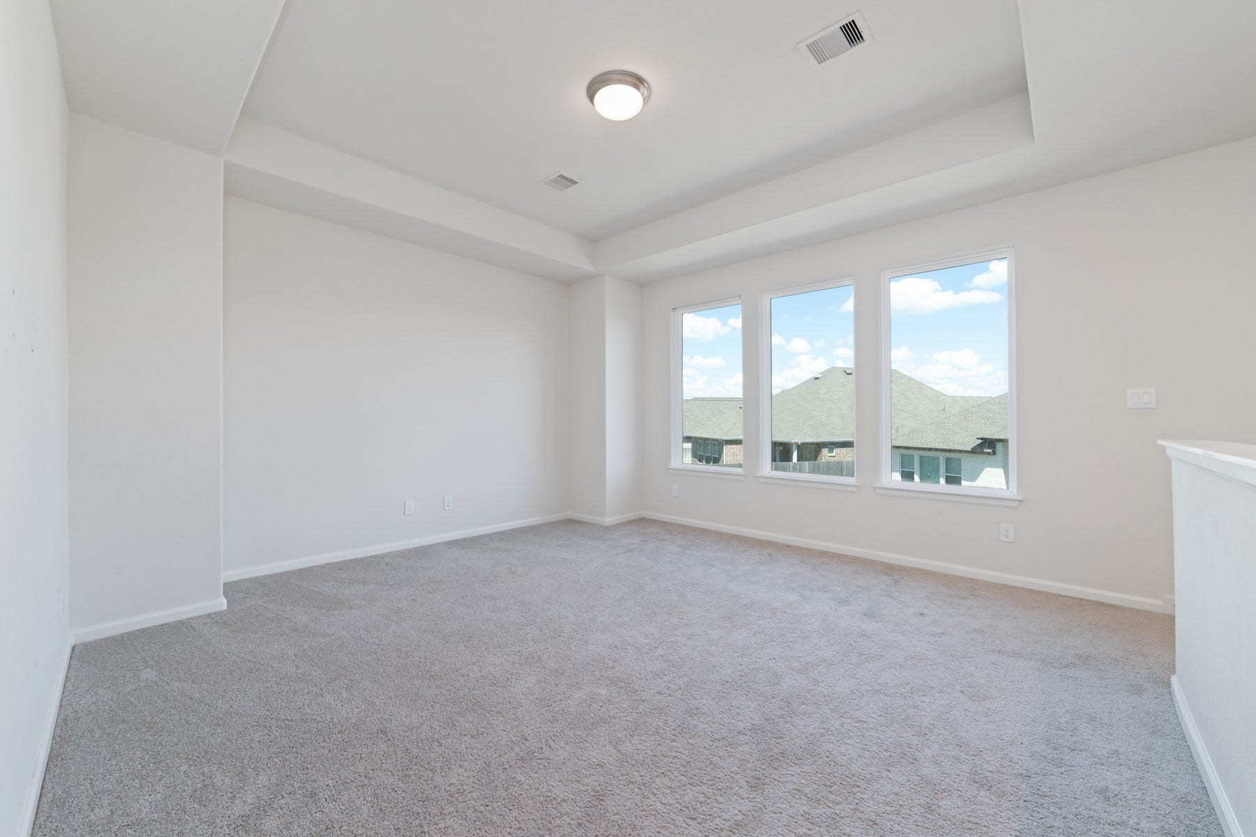 Expansive game room filled with natural light, offering the perfect space for entertainment and relaxation upstairs
