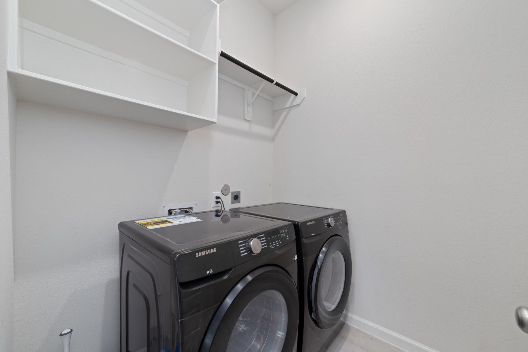 Laundry room featuring with convenient shelving for storage.
