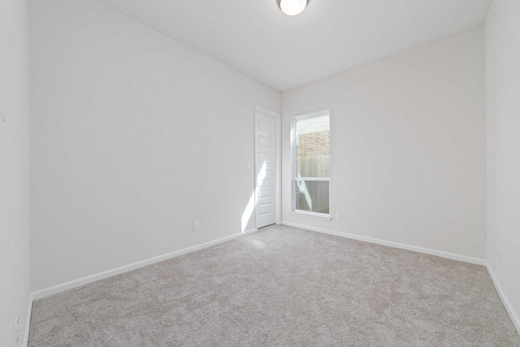 Discover the inviting charm of Bedroom #2, featuring soft carpeting, ample natural light, and a serene ambiance perfect for relaxation.