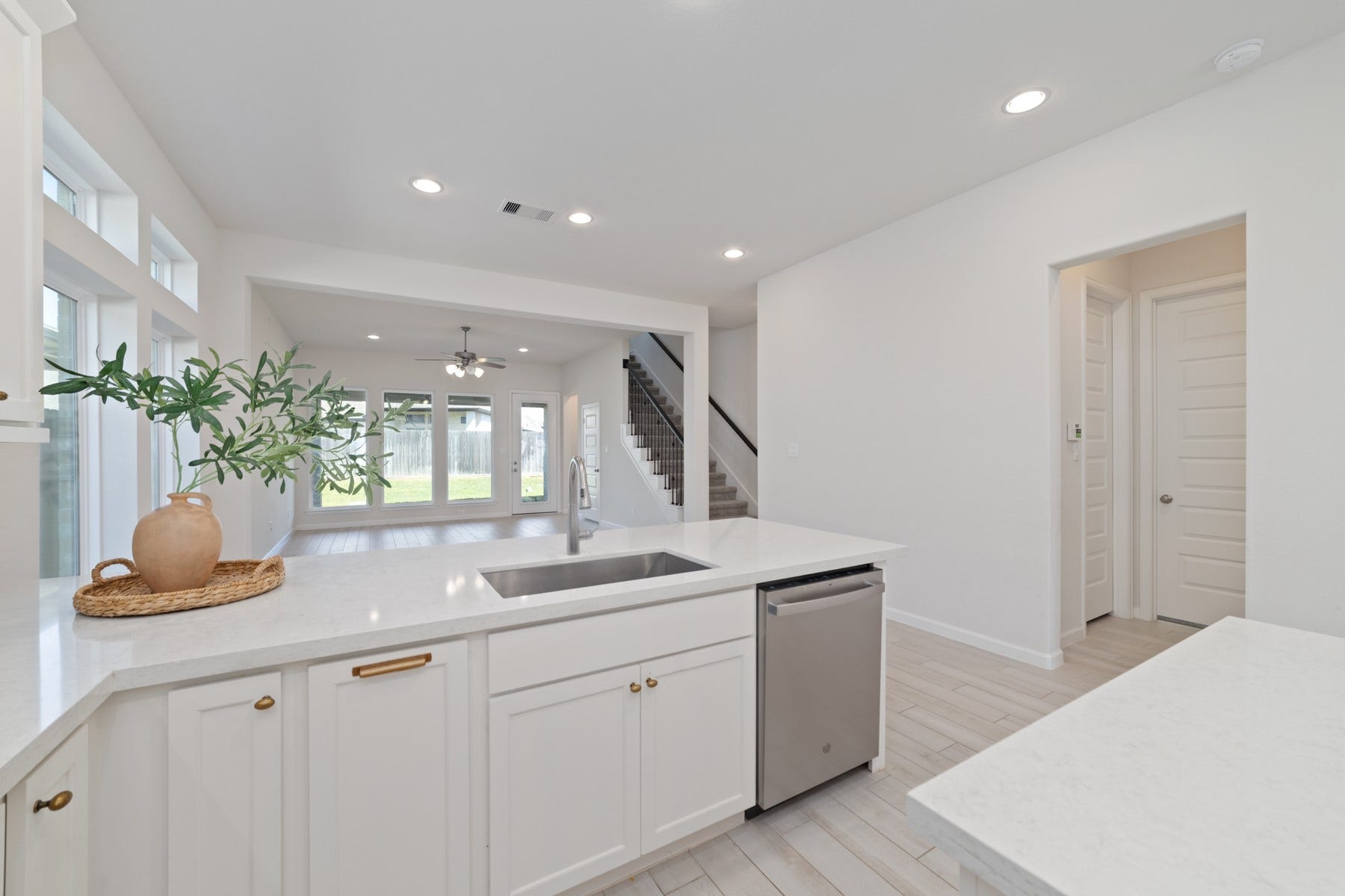 Bright and spacious open-concept kitchen with modern finishes, featuring a large island, ample cabinetry, and seamless flow into the living area with abundant natural light.
