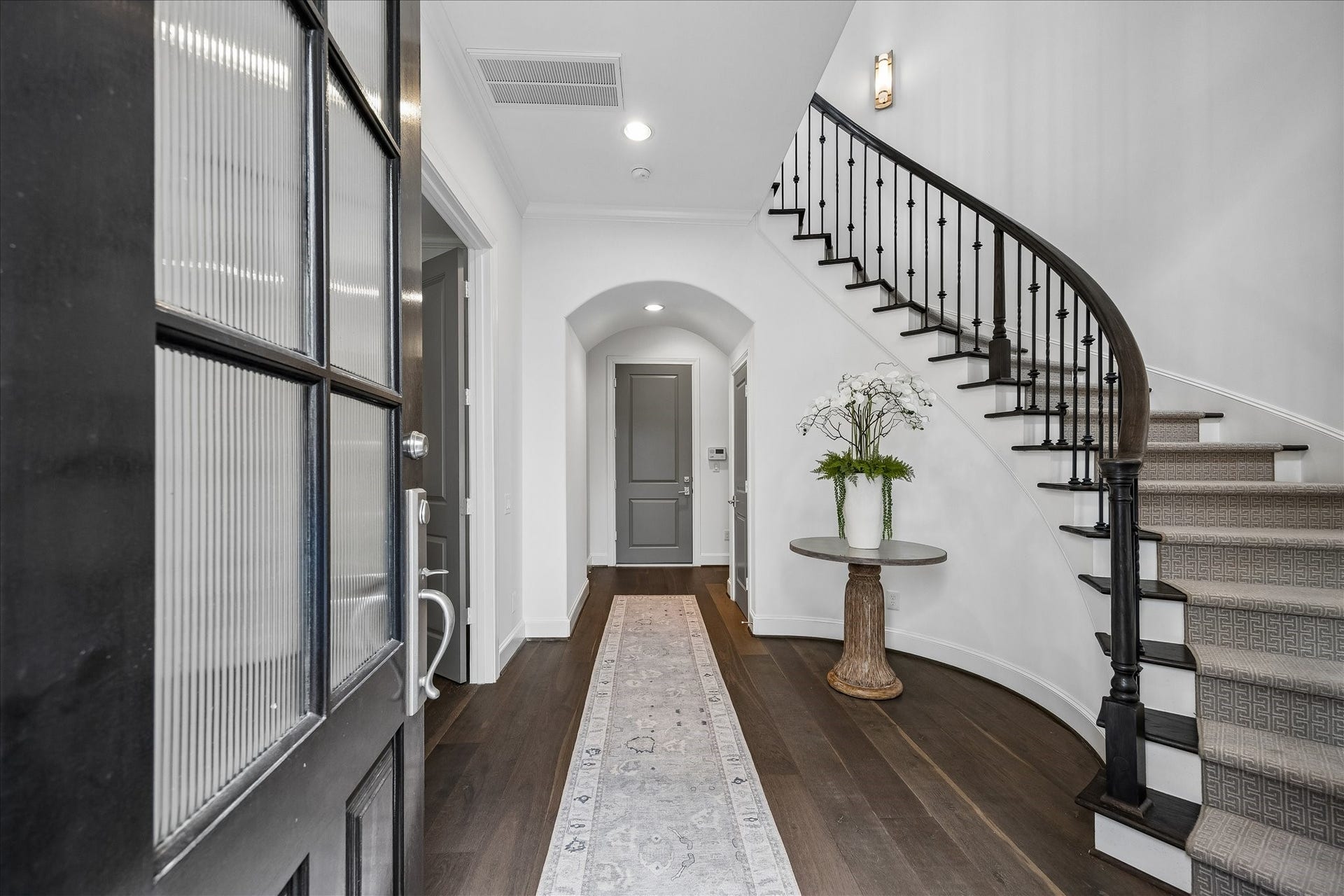 1208 Mosaico Lane, Houston, TX 77055 1st floor entry to a bedroom, ensuite bath, door to 3 car garage, storage and entrance to elevator for all 3 floors
