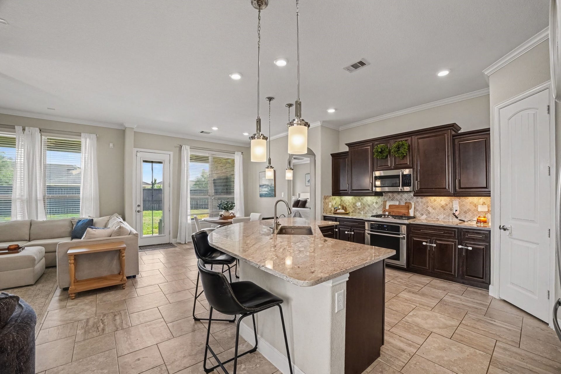 26438 Morgan Creek Lane, Katy, TX 77494 This open-concept gourmet kitchen serves as the ideal gathering spot, blending functional modern living with rich architectural finishes.