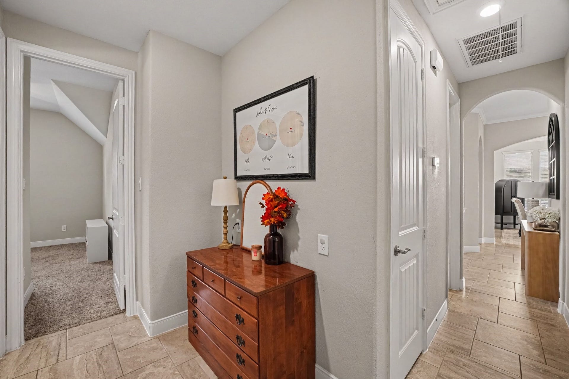 26438 Morgan Creek Lane, Katy, TX 77494 This central hallway hub demonstrates the functional, well-designed split-floor plan of the home. Modern neutral paint, crisp white trim, and continuous tile flooring tie the corridors together, creating a clean, cohesive transition between living areas and private quarters.