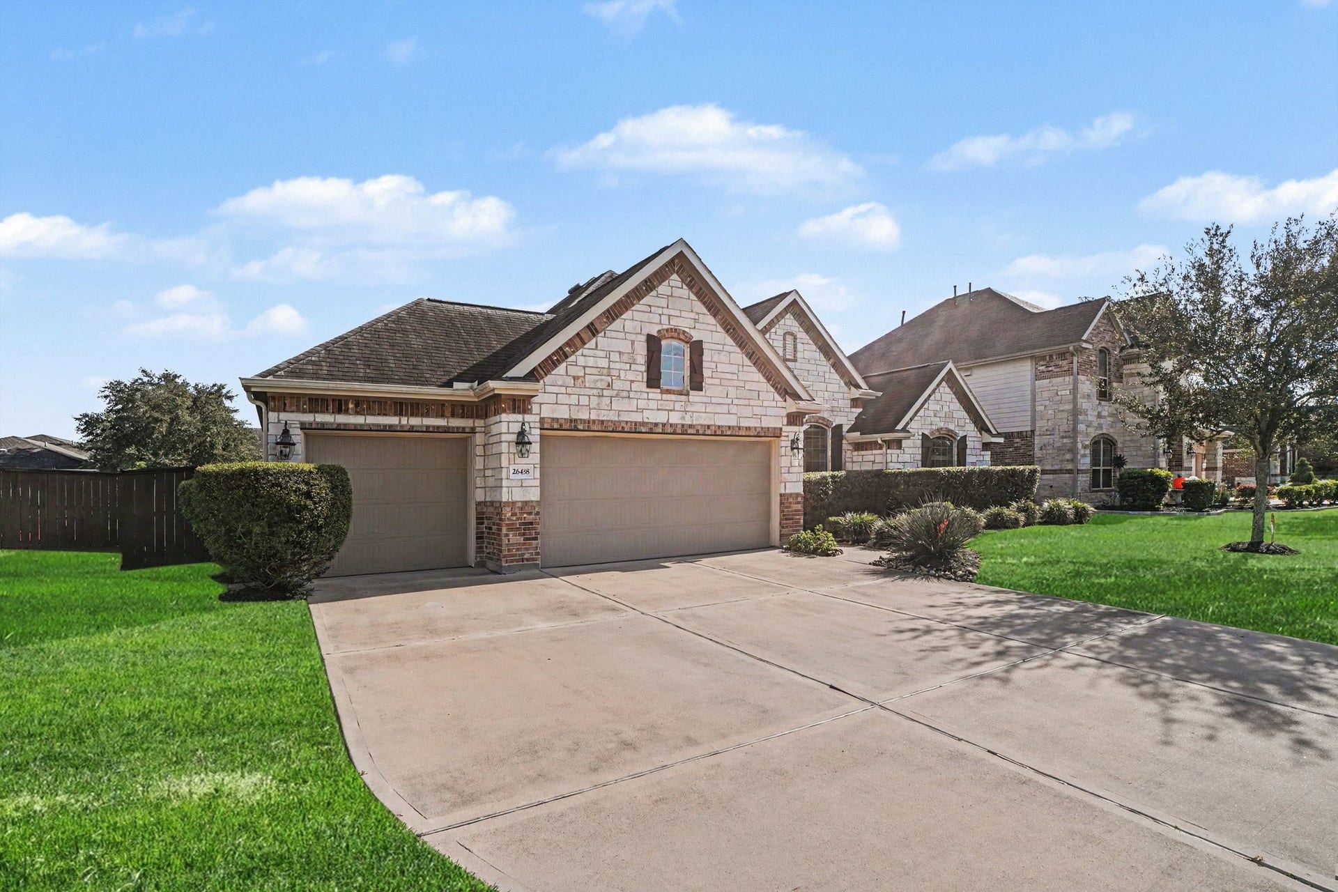 26438 Morgan Creek Lane, Katy, TX 77494 Features a generous double garage alongside a separate single garage bay, providing ample space for parking, storage, or a workshop, complete with an extra-wide concrete driveway.
