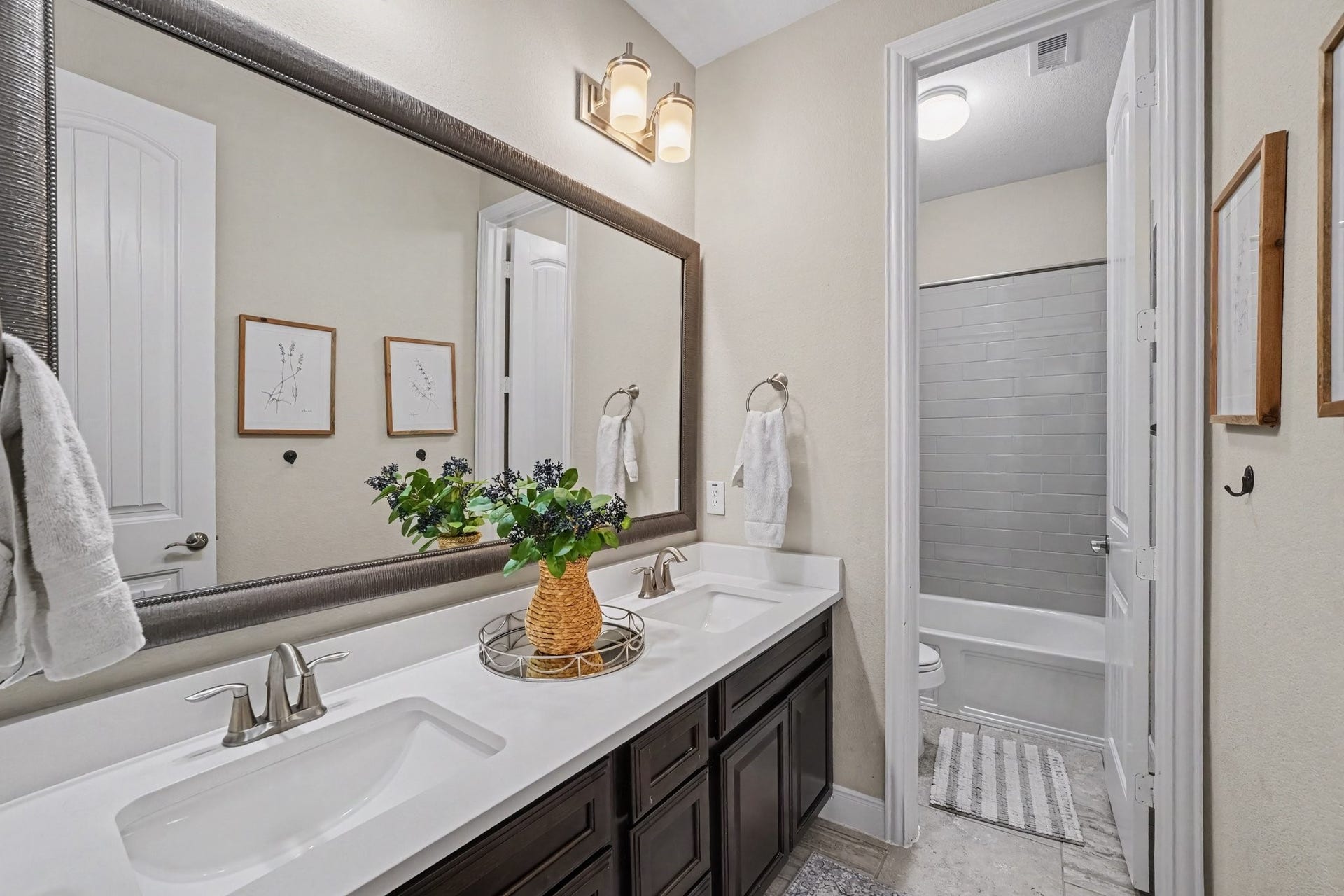 26438 Morgan Creek Lane, Katy, TX 77494 This beautifully appointed full bathroom offers exceptional convenience and modern style for family or guests. Through a separate interior door, the private toilet and shower/tub combination area showcases sleek, grey subway tile surround, ensuring seamless functionality and privacy during busy mornings.
