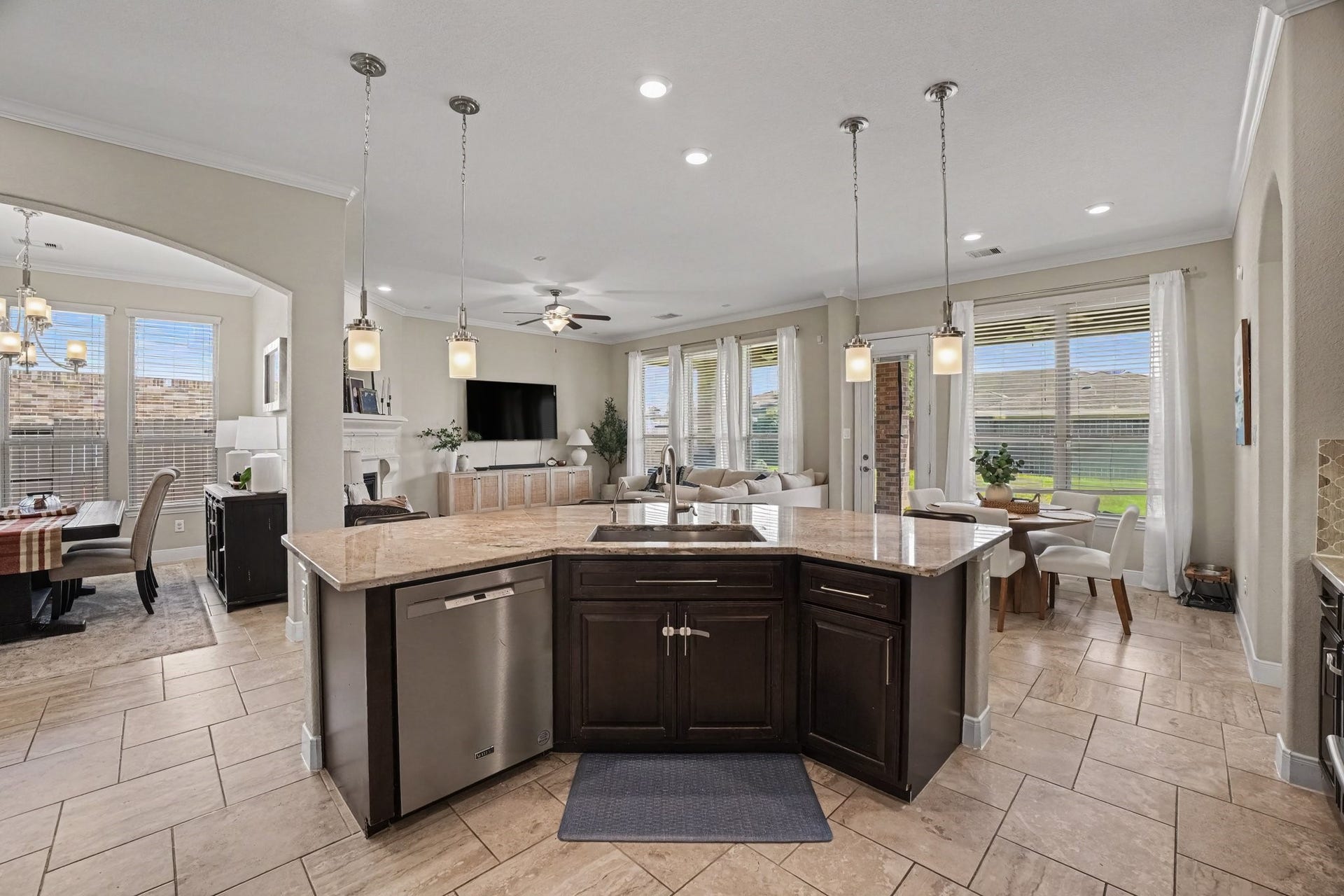 26438 Morgan Creek Lane, Katy, TX 77494 The open design flows effortlessly into the formal dining room through an elegant arched opening, as well as into the main living room, keeping everyone connected whether cooking, dining, or entertaining guests.