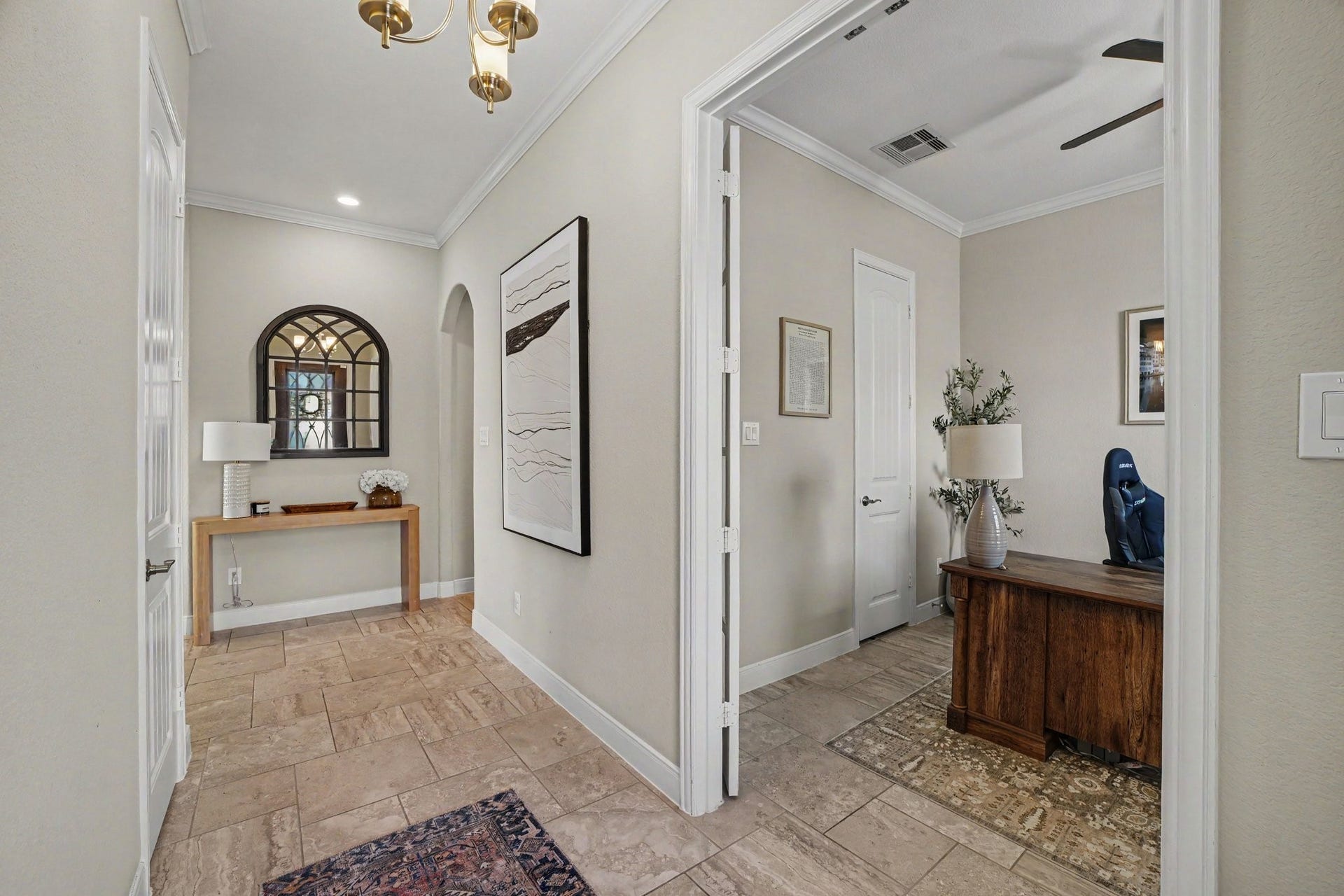 26438 Morgan Creek Lane, Katy, TX 77494 This vantage point highlights the seamless flow and versatile layout of the main hallway. Down the hall, a stylish console table paired with a arched, windowpane-style mirror. Just off the entryway, glass-paneled double doors open into a dedicated executive home office.
