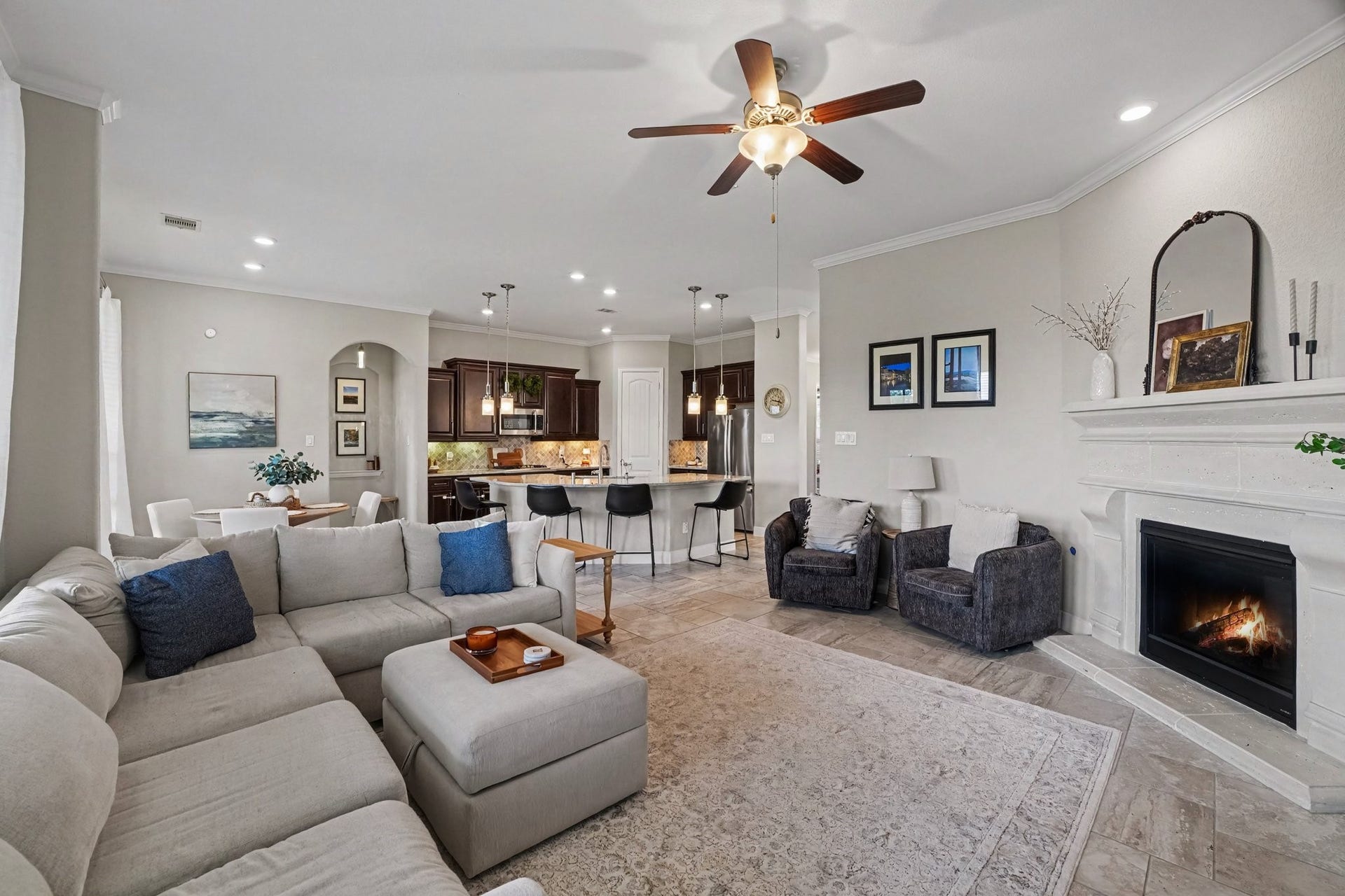 26438 Morgan Creek Lane, Katy, TX 77494 A classic, grand mantel and cozy fireplace create an elegant focal point for intimate gatherings or relaxing evenings. This living room opens to the kitchen!