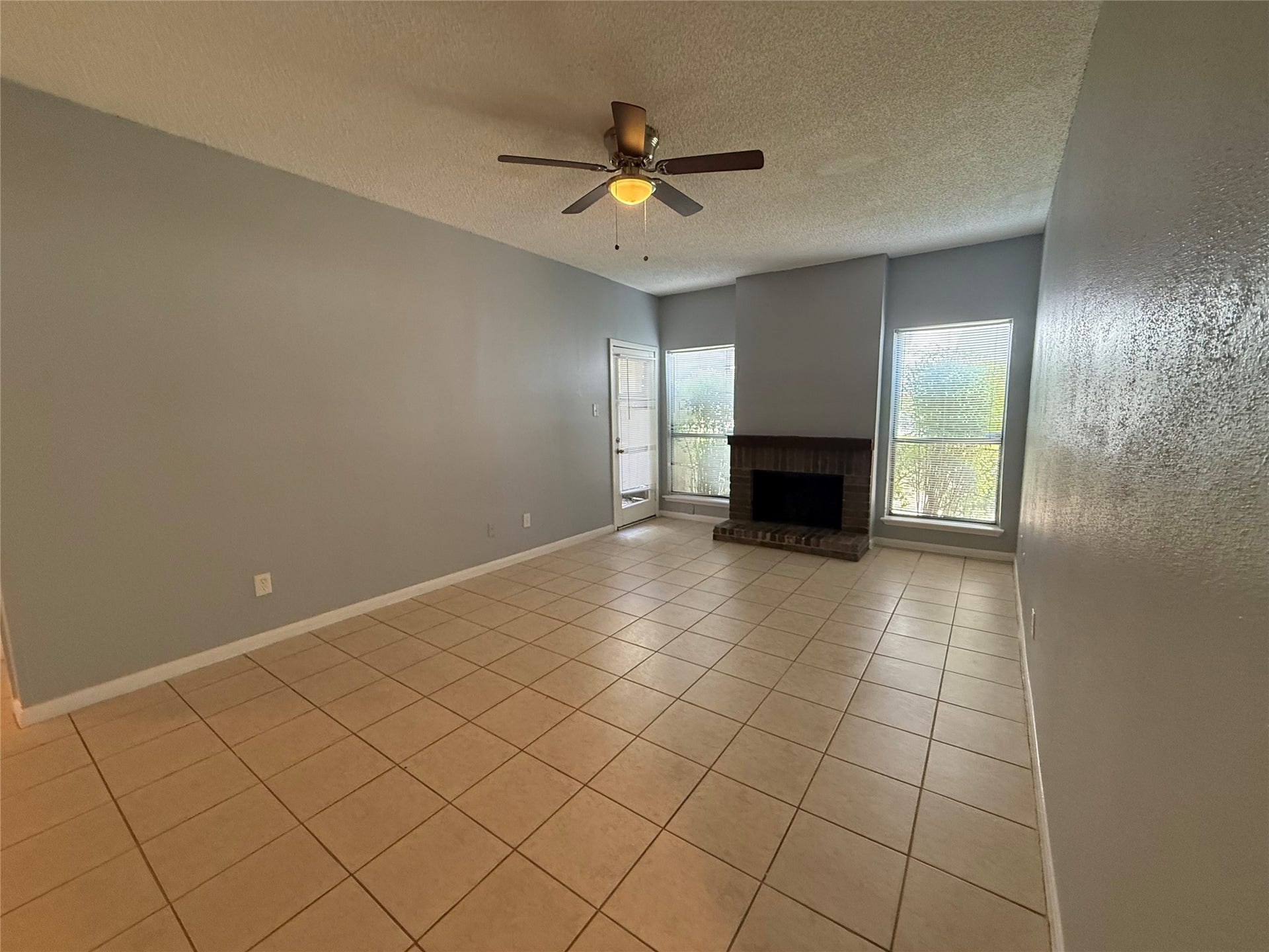 10049 Westpark Drive, #107, Houston, TX 77042 Spacious living room with wood burning fireplace