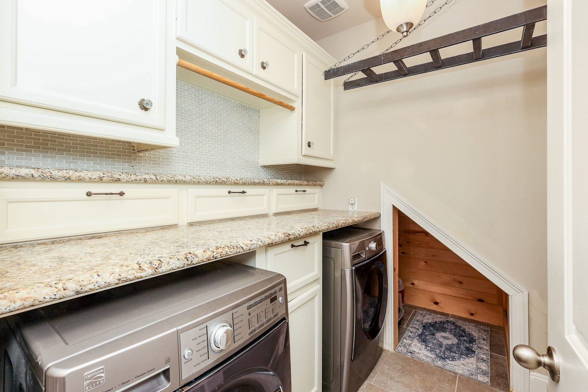 4715 Trickle Creek Court, Fulshear, TX 77441 Laundry room with built-in cabinets, laundry shoot, and cedar finished alcove.