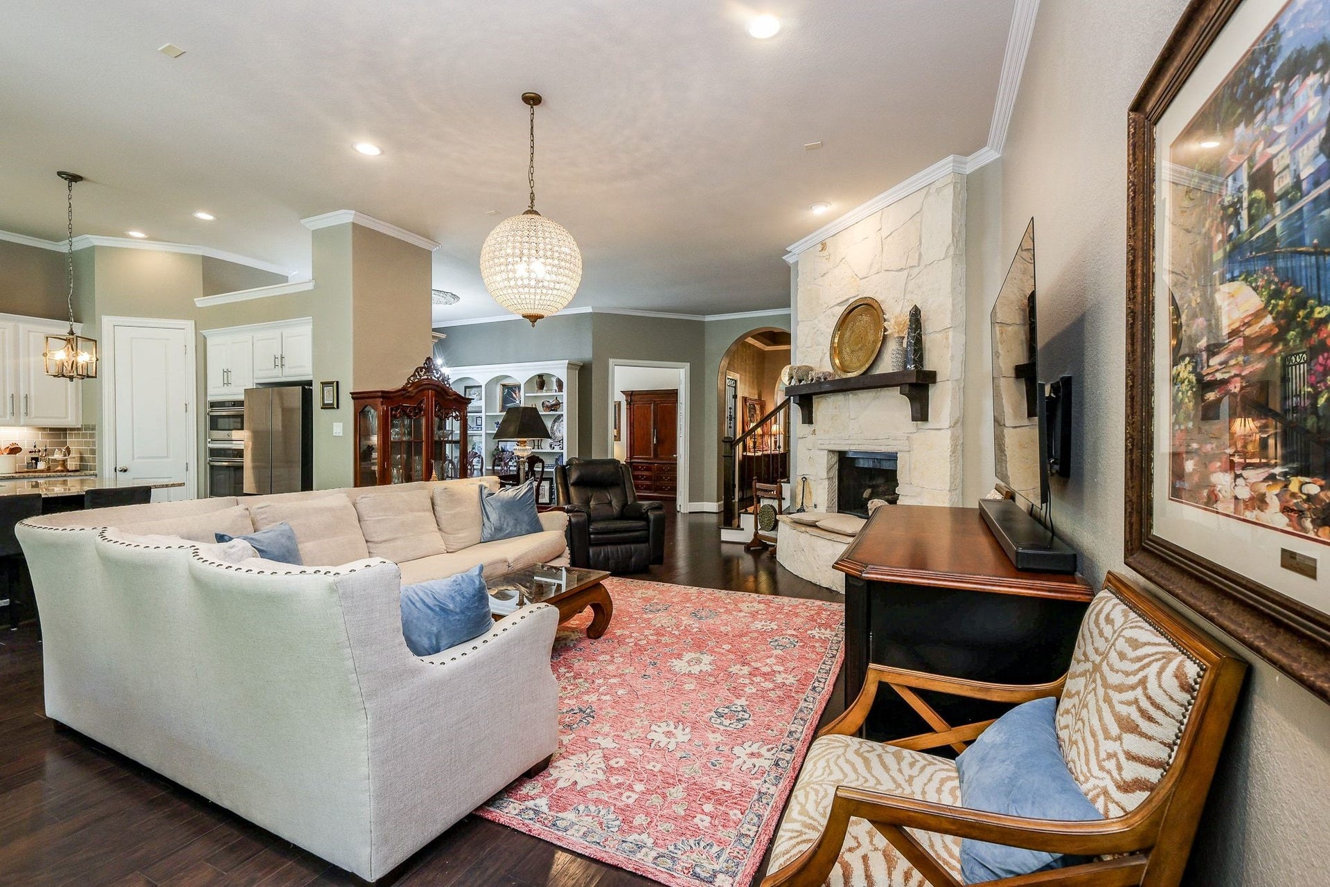 4715 Trickle Creek Court, Fulshear, TX 77441 Living room is open to the kitchen and formal dining room.