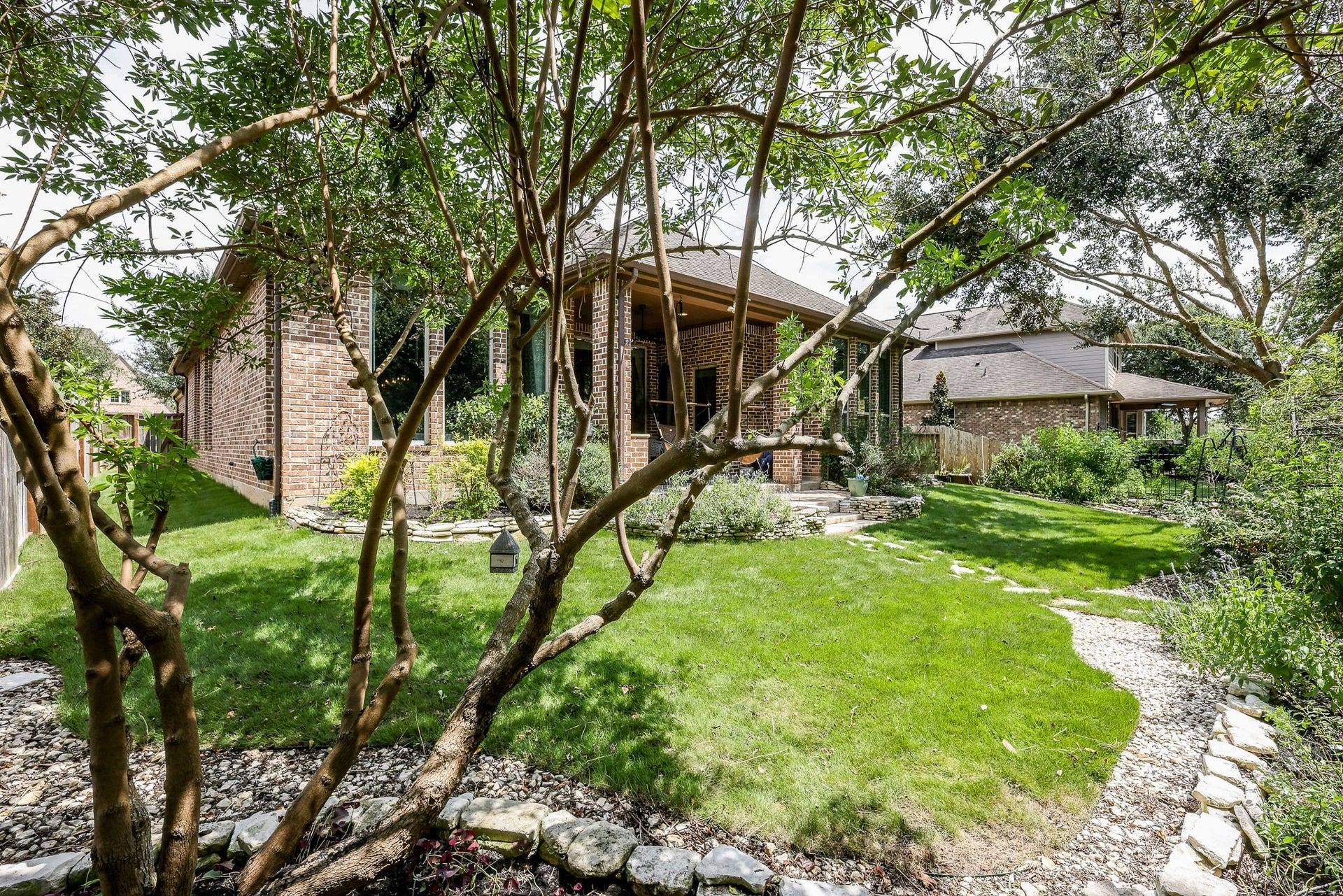 4715 Trickle Creek Court, Fulshear, TX 77441 Backyard with iron fence and gate out to the back.