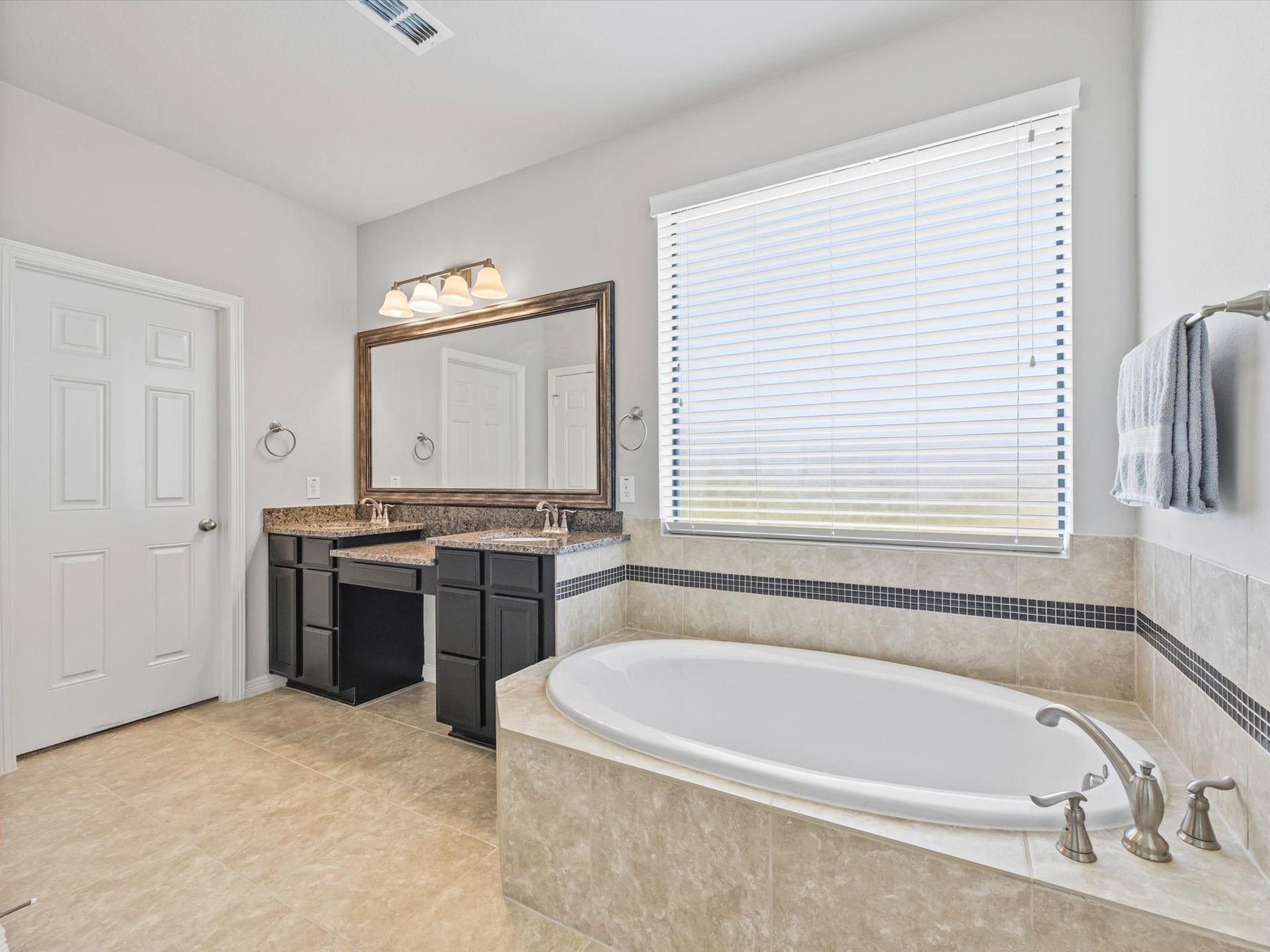 4302 Kent Ranch Court, Katy, TX 77494 The spacious primary bathroom is thoughtfully designed with dual sinks, an expansive vanity area, and ample counter space, providing both style and everyday functionality.