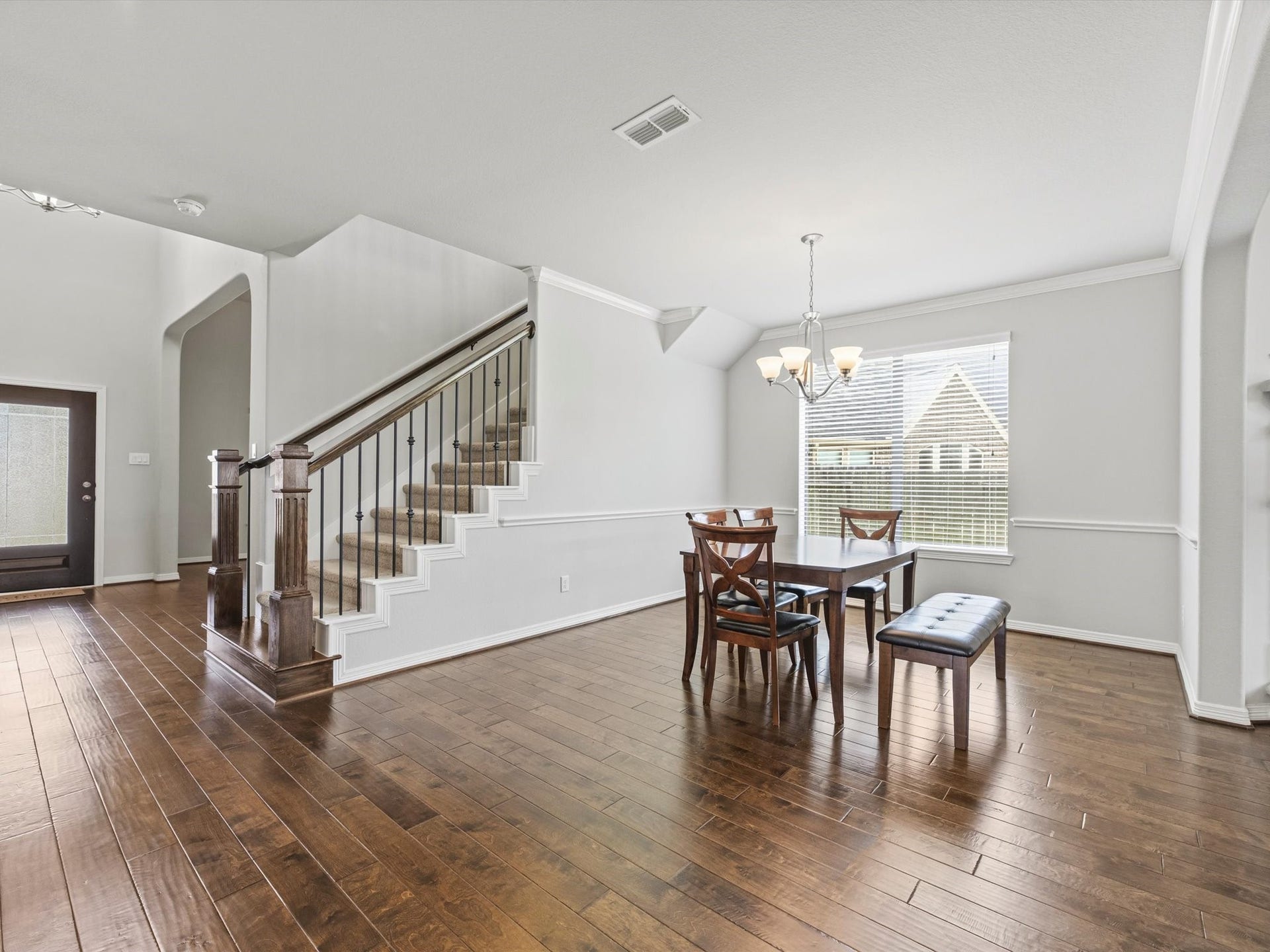 4302 Kent Ranch Court, Katy, TX 77494 The formal dining room is filled with abundant natural light, creating a warm and welcoming atmosphere for gatherings. Featuring the same beautiful wood flooring that flows throughout the main living areas.