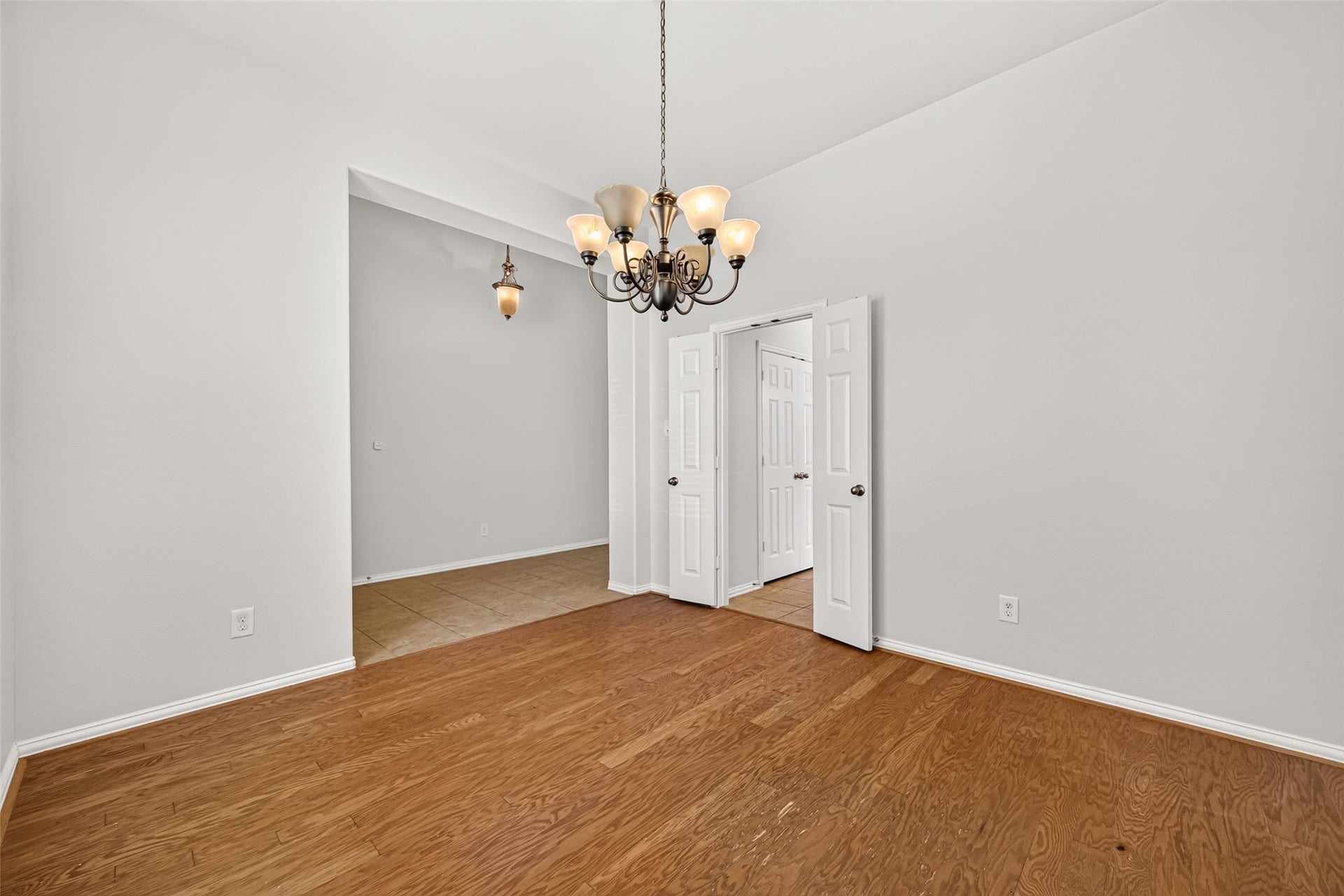 8155 Laughing Falcon Trail, Conroe, TX 77385 Formal dining room with a wide opening to the entry area and double doors providing direct access to the kitchen.