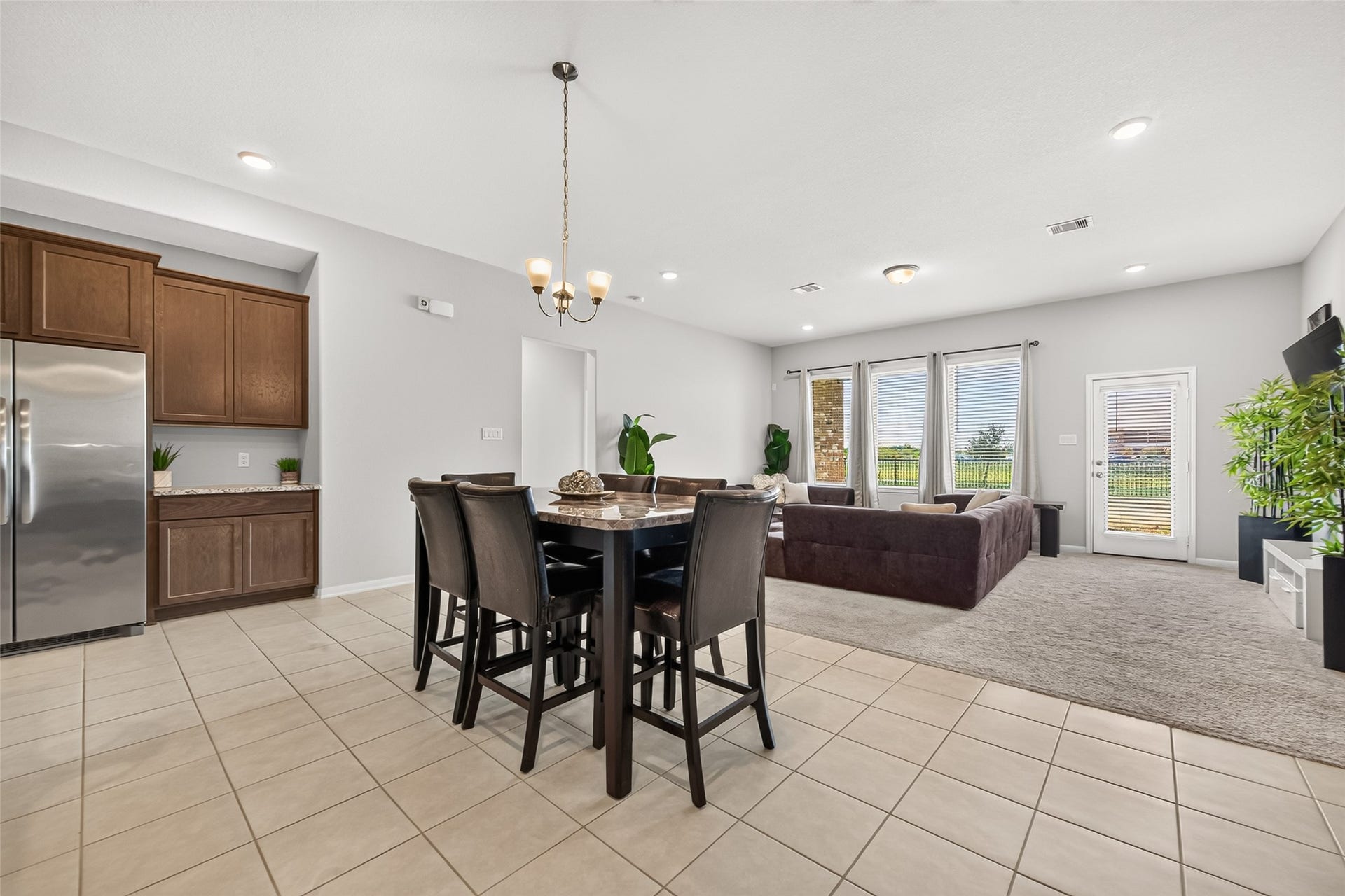 10707 Amador Peak Drive, Rosharon, TX 77583 Dining area open to the living room, extra cabinetry and counterspace to the left. Plenty of natural light coming in this home, blinds throughout. Inquire about furniture, most available.