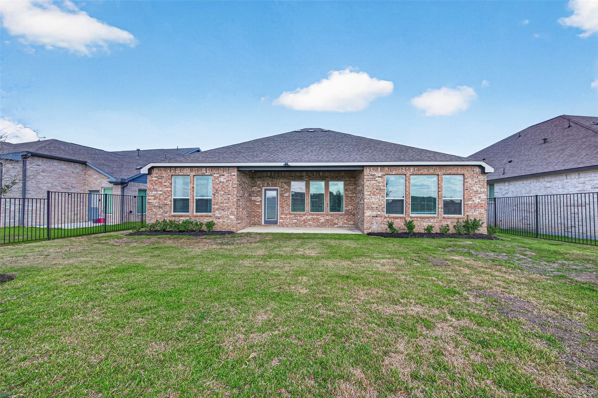 10707 Amador Peak Drive, Rosharon, TX 77583 View of the backyard & covered back patio, home is 4-sided brick, great, low maintenance overtime. French drains installed & full sprinkler system. Fresh landscaping!