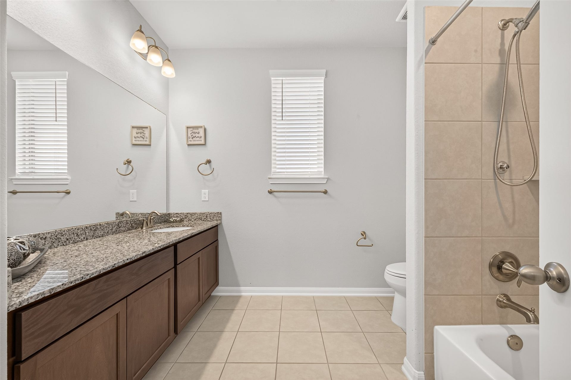 10707 Amador Peak Drive, Rosharon, TX 77583 Shared bathroom between secondary bedrooms, shower-tub combo, window provides a well lit space. Plenty of countertop space & cabinets for storage