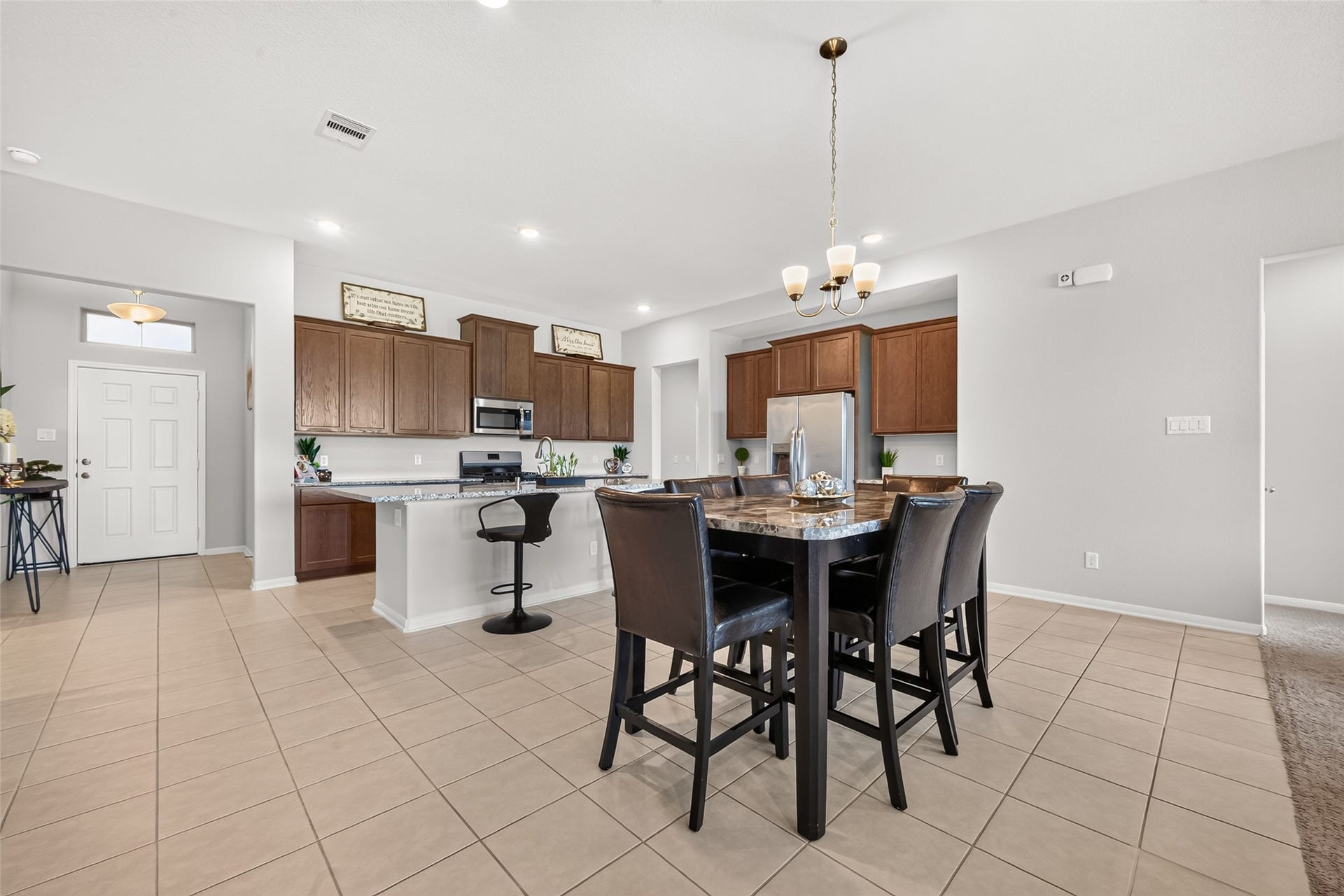 10707 Amador Peak Drive, Rosharon, TX 77583 Dining area open to the kitchen and living area, recessed lighting continues. Inquire about furniture, most available.