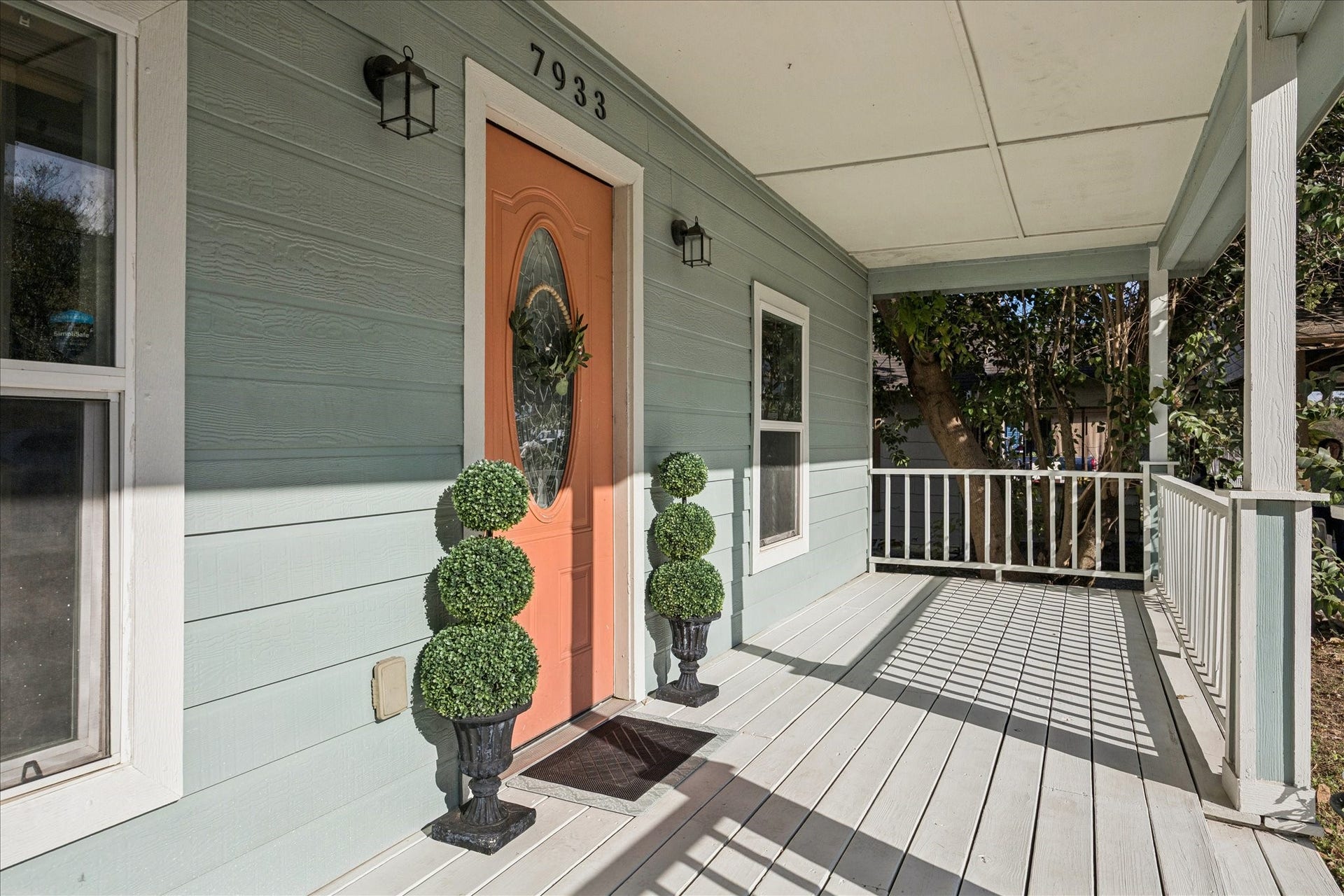 7933 Elwood Street, Houston, TX 77012 This inviting porch is covered, offering shade and a welcoming entry with a classic railing, perfect for relaxing or greeting guests.