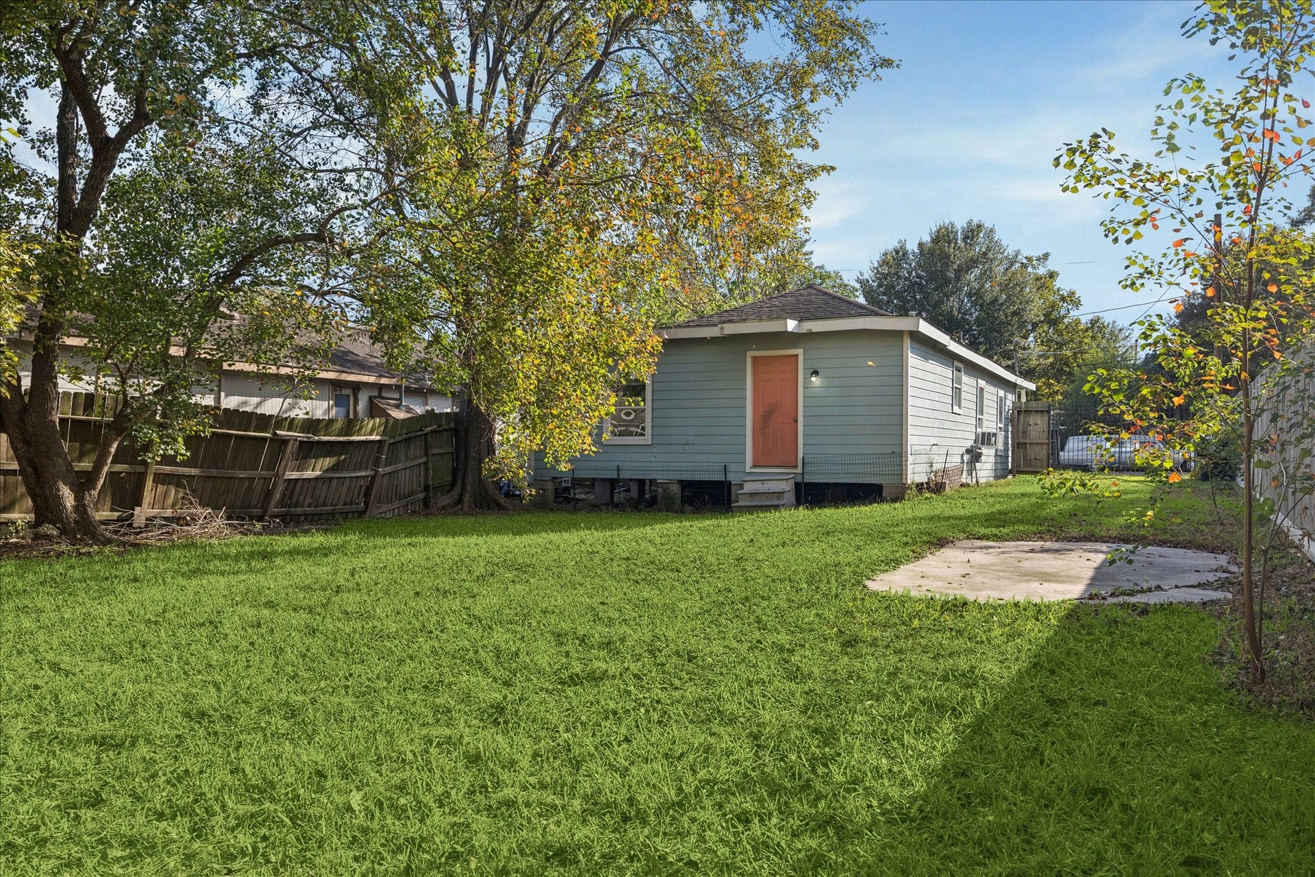 7933 Elwood Street, Houston, TX 77012 The yard has a grassy area and a small concrete slab, offering potential for outdoor activities.
