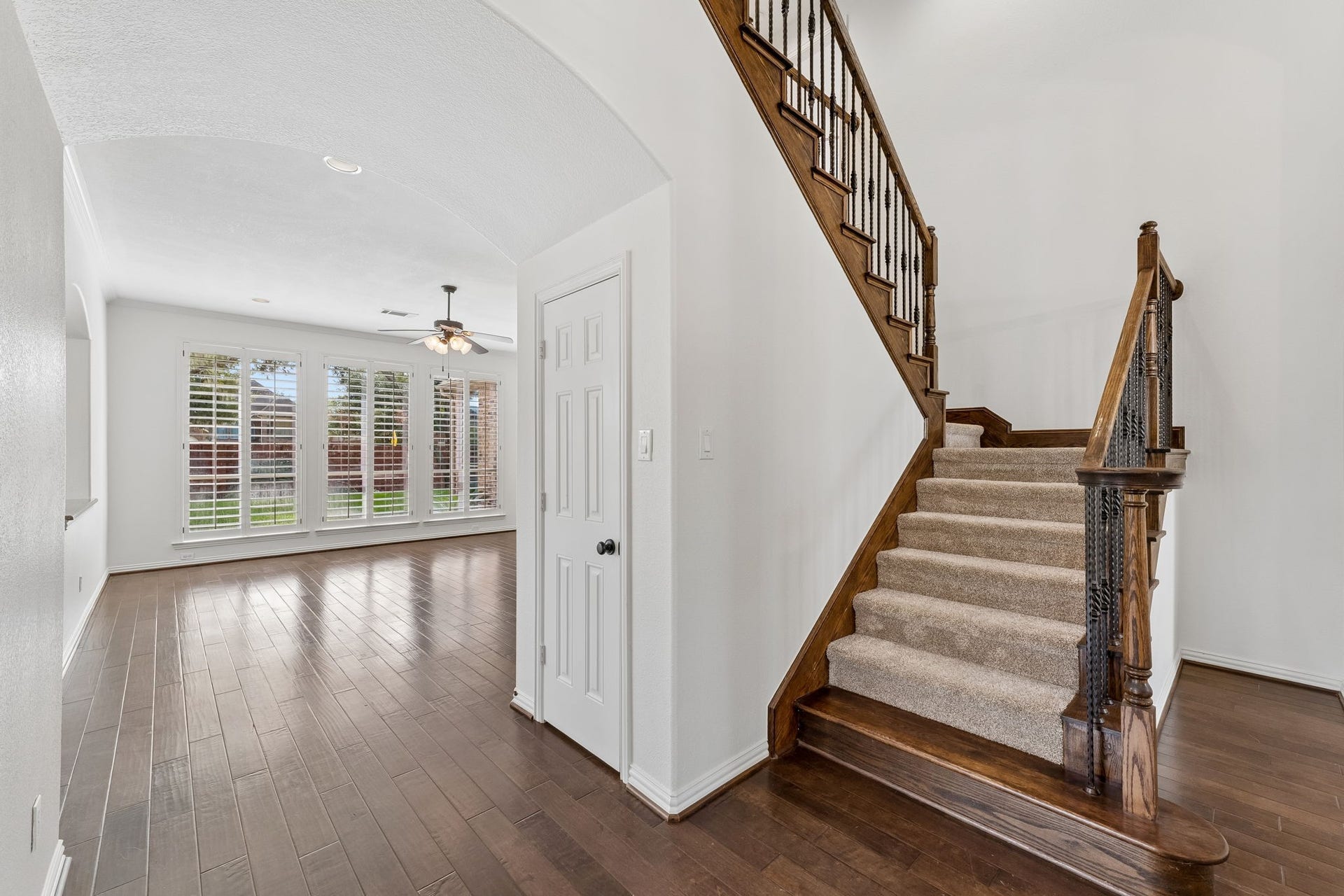 8210 Thunder Ridge Way, Missouri City, TX 77459 Step into the inviting downstairs family room, featuring access to a spacious closet and a staircase leading to the upstairs living areas and three secondary bedrooms.