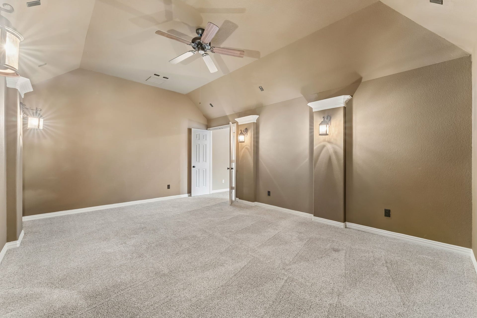 8210 Thunder Ridge Way, Missouri City, TX 77459 Spacious media room with rich, dark brown walls, perfect for creating a cozy entertainment space.