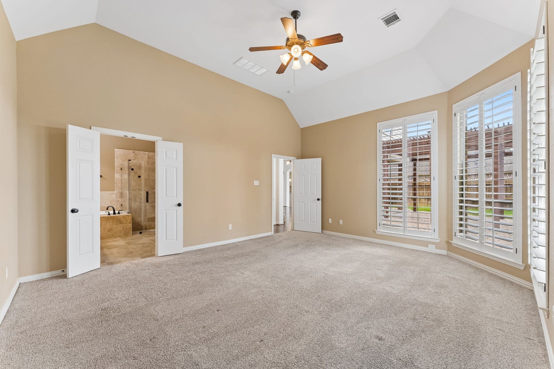 8210 Thunder Ridge Way, Missouri City, TX 77459 Spacious primary bedroom with elegant double doors leading to the ensuite bathroom.