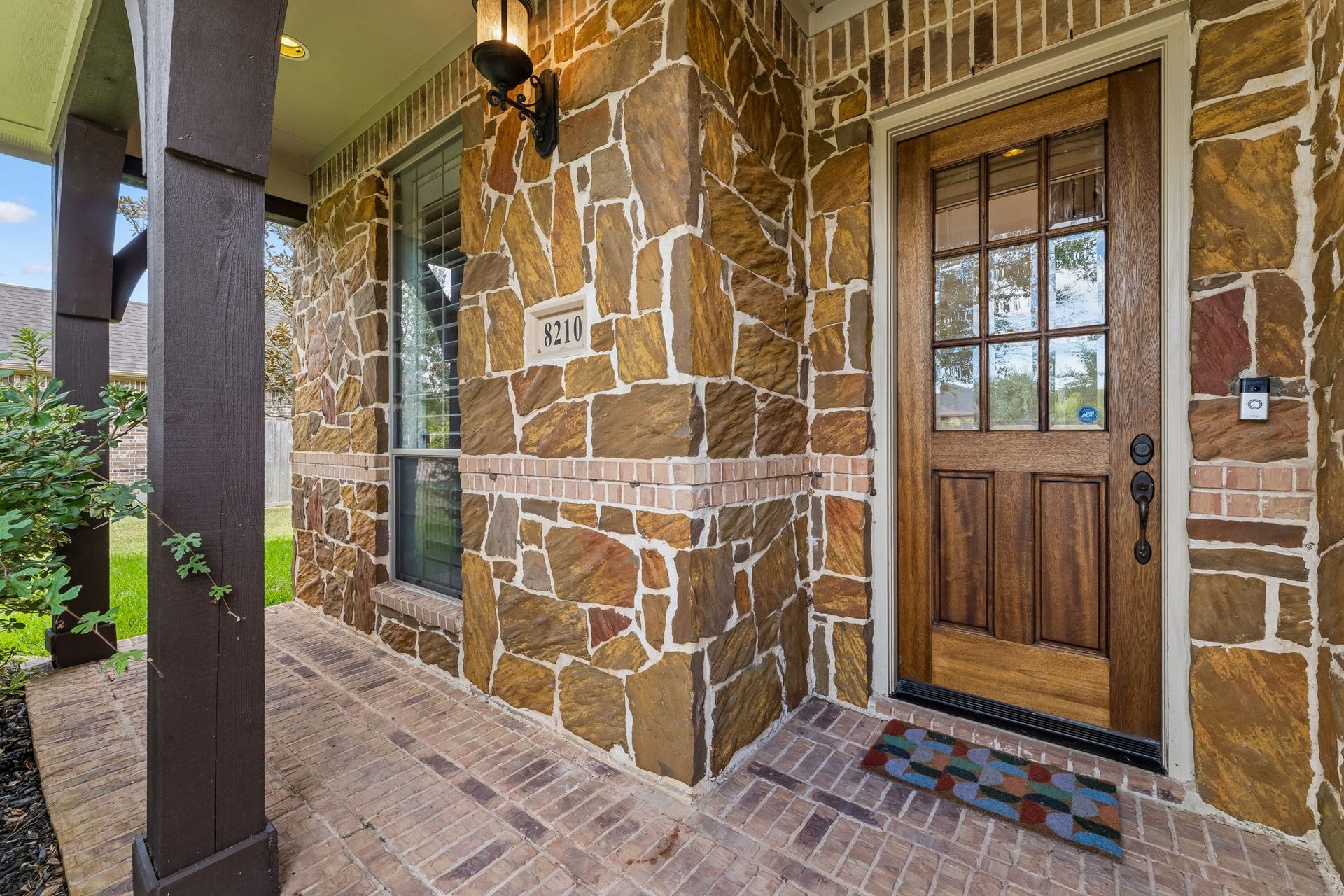 8210 Thunder Ridge Way, Missouri City, TX 77459 Charming porch featuring elegant stone and brick craftsmanship.