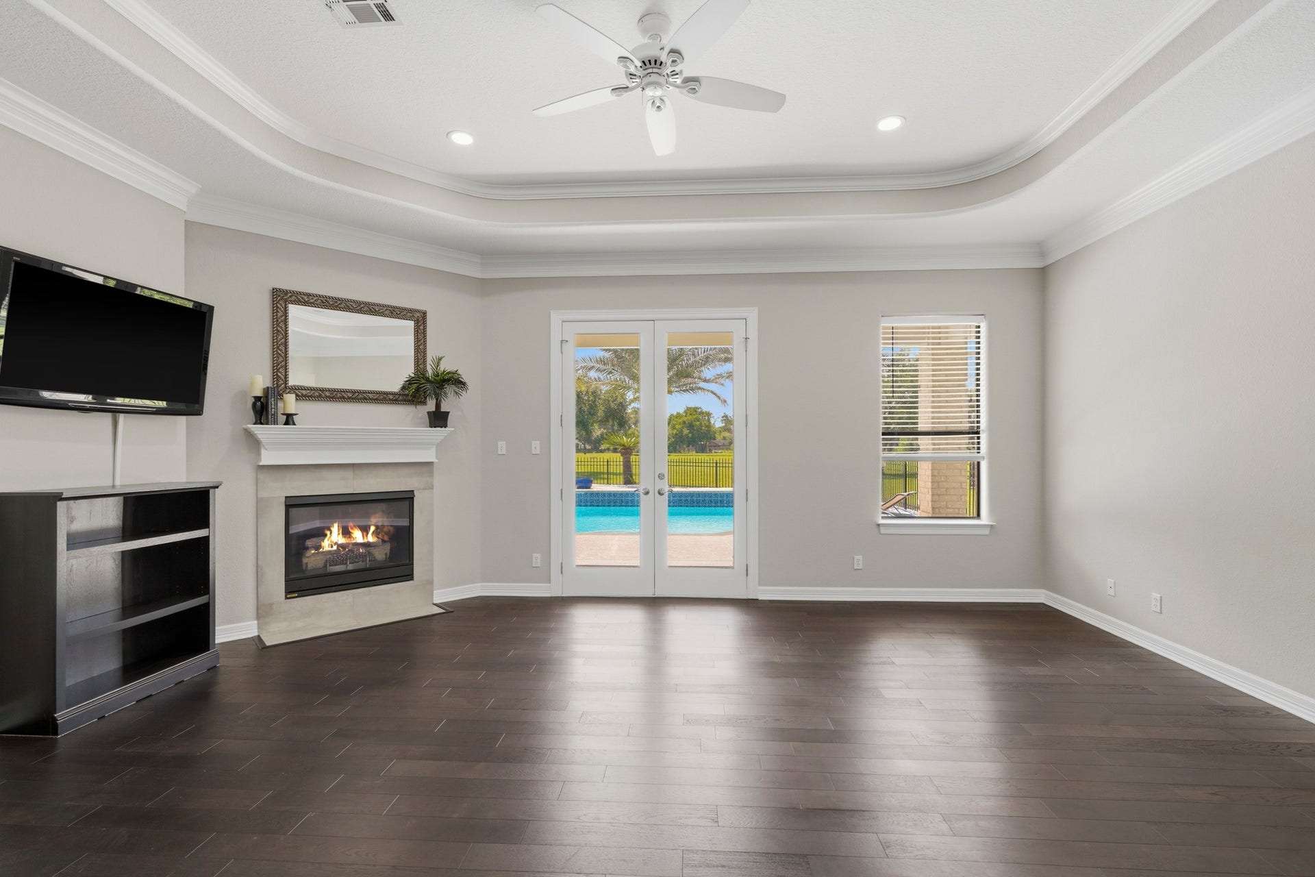 835 Hall Road, Alvin, TX 77511 Expansive primary suite with tray ceiling and fireplace