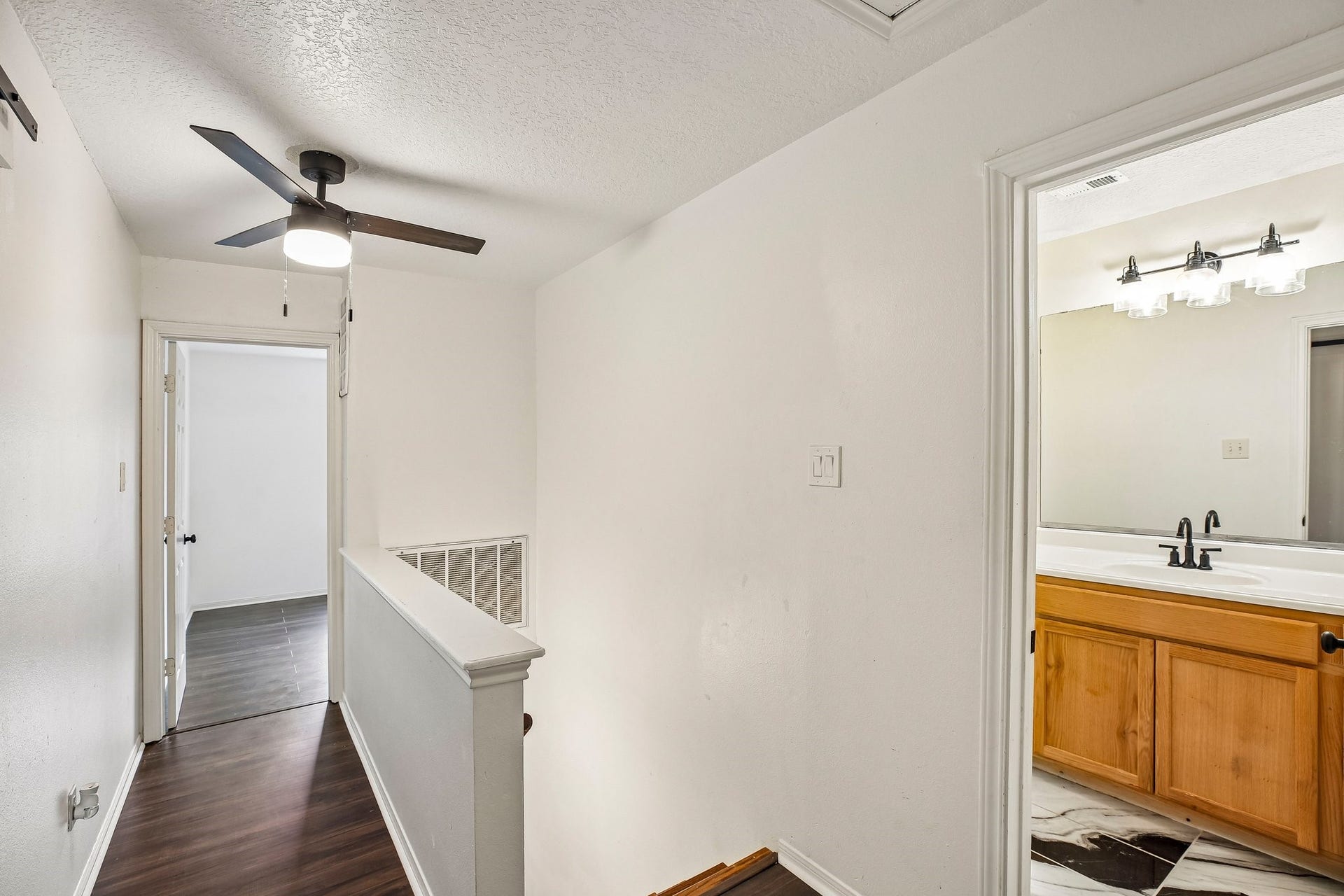 5501 Pecos Street, Dickinson, TX 77539 The second floor features two additional bedrooms, a full bathroom with marble flooring, and a large storage closet that was previously used as a craft room.