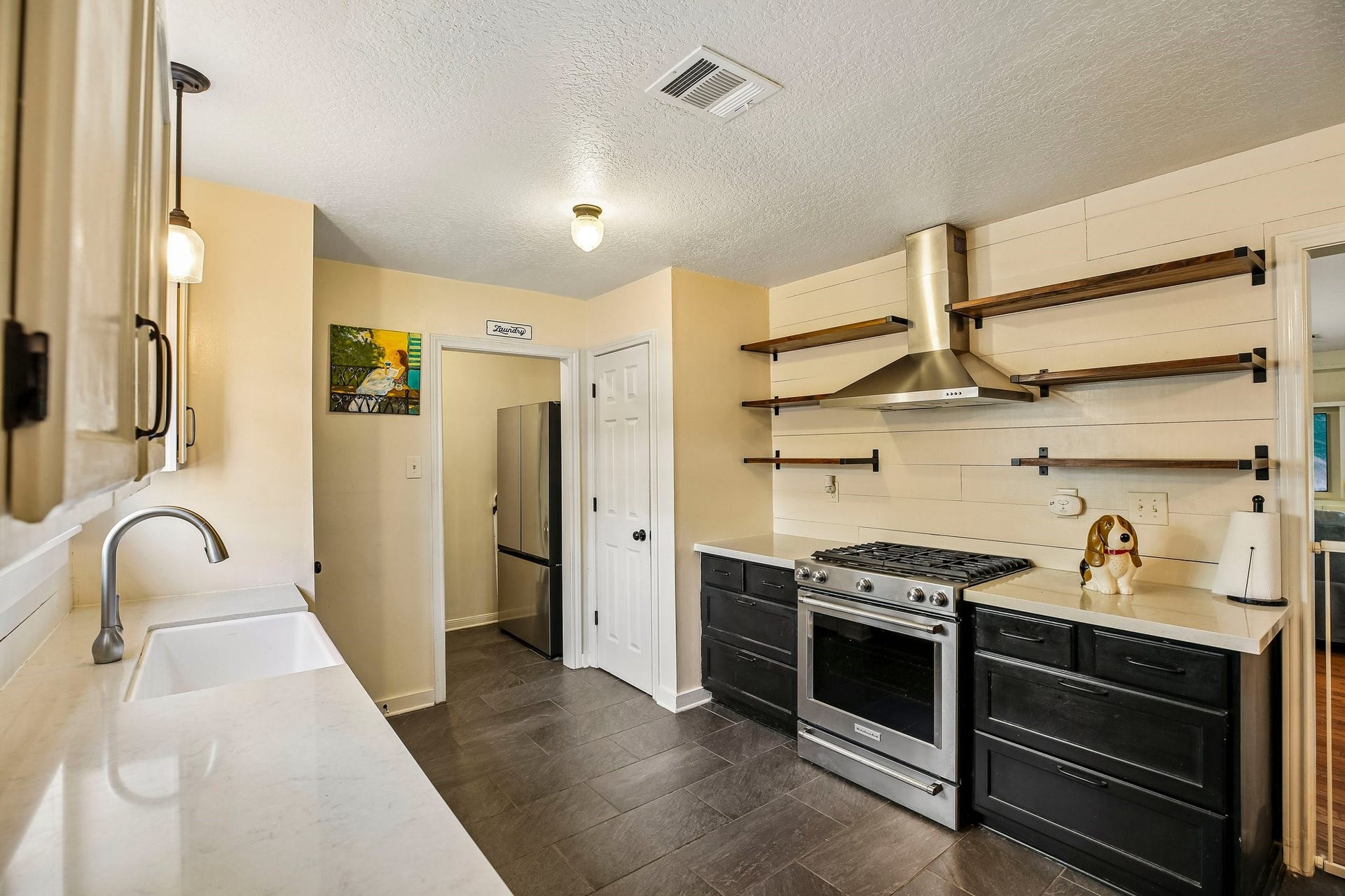 5501 Pecos Street, Dickinson, TX 77539 The kitchen features a stainless steel KitchenAid gas oven and range.