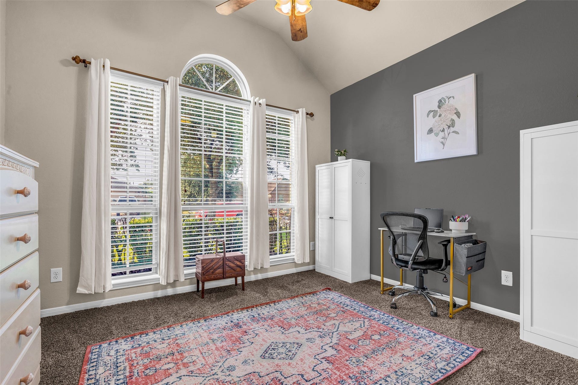 The front bedroom enjoys tall windows with palladium top overlooking the front yard. More stunning natural light fills the room with custom paint scheme. A double door closet works double duty to hold your wardrobe, or office supplies depending upon how this room is used.
