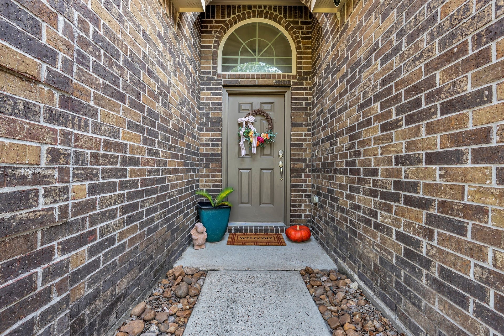 Welcome friends and family under the brick archway that leads to home sweet home.