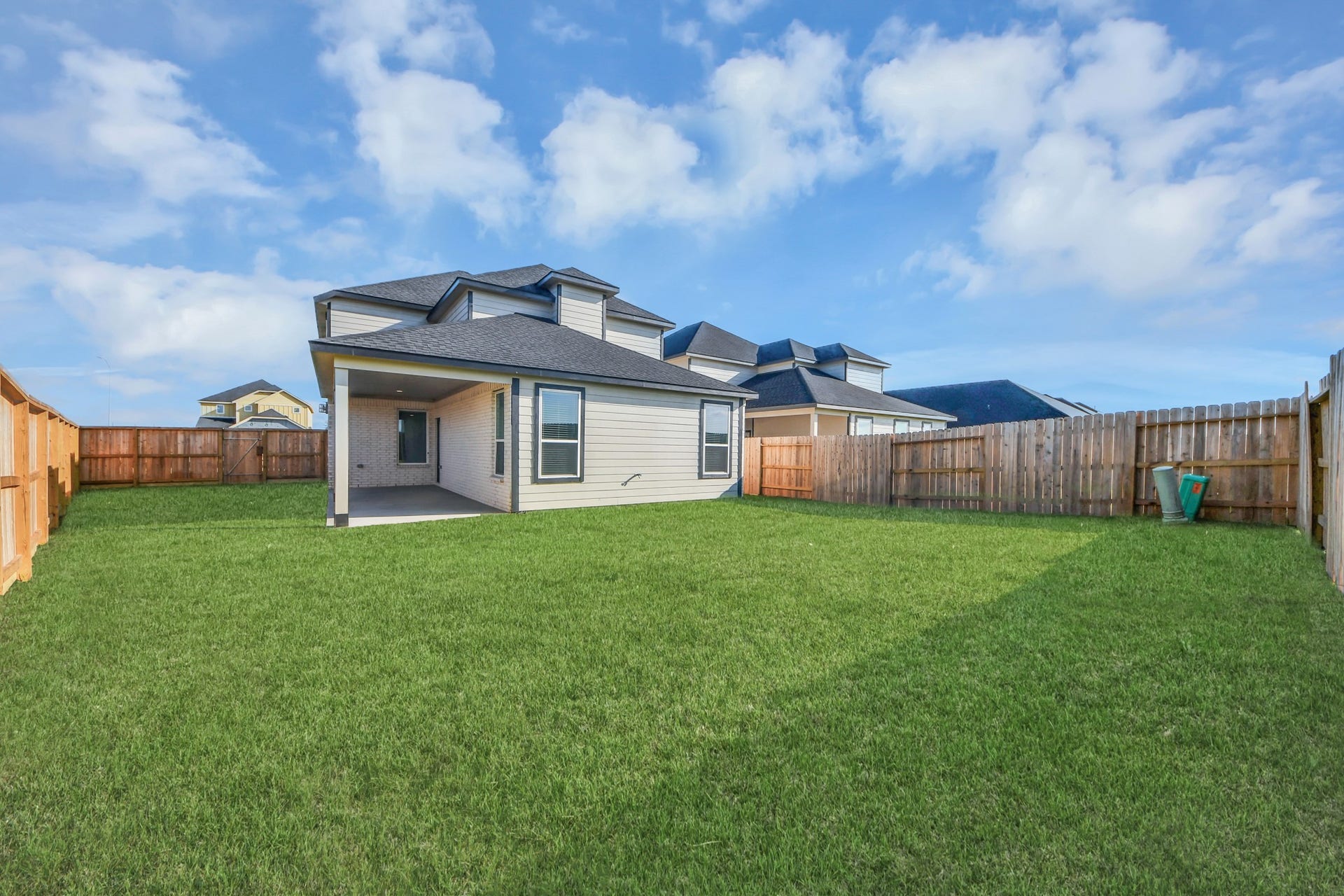 Explore the expansive backyard with its inviting covered patioa perfect blend of space for the kids to play and adults to unwind. Ideal for creating your outdoor oasis, this backyard accommodates patio furniture, a BBQ pit, and endless possibilities for leisure and entertainment. Sample photo of completed home with similar floor plan. Actual colors and selections may vary.