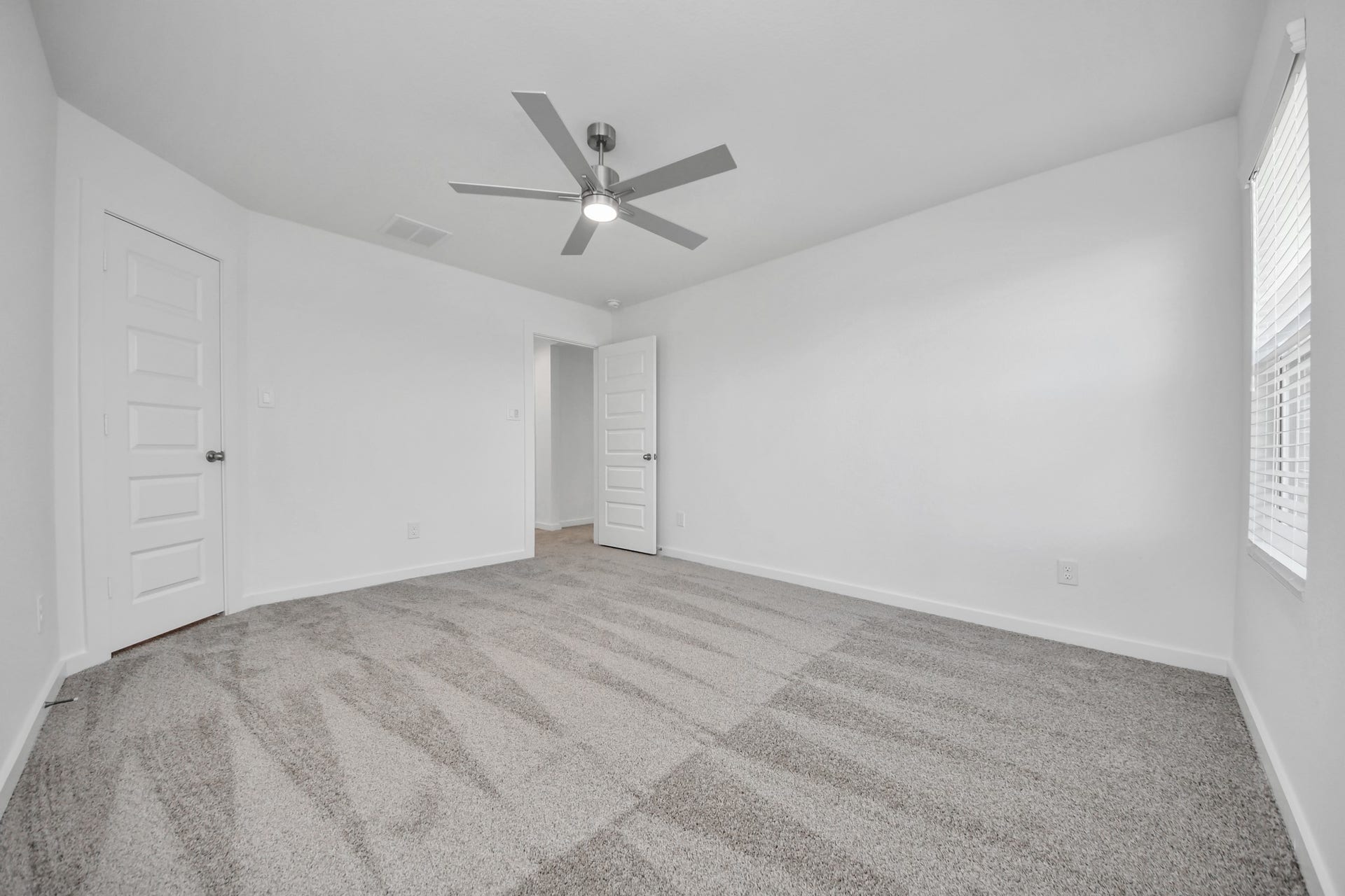 Generously sized secondary bedrooms featuring spacious closets, soft and inviting carpeting underfoot, large windows allowing plenty of natural light, and the added touch of privacy blinds for your personal retreat. Sample photo of completed home with similar floor plan. Actual colors and selections may vary.