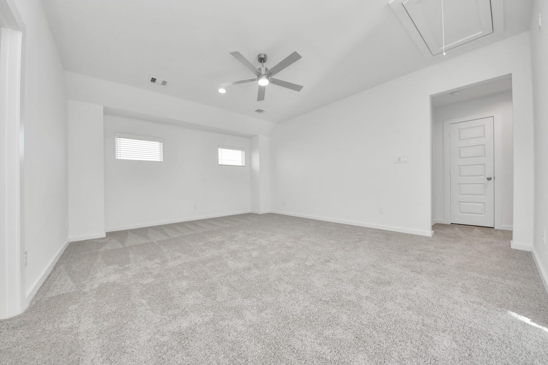 Ascend to relaxation in this fantastic game room! Ideal for both casual gatherings and adult gaming, it boasts plush carpet, lofty ceilings, custom paint, and ample windows for abundant natural light. Sample photo of completed home with similar floor plan. Actual colors and selections may vary.