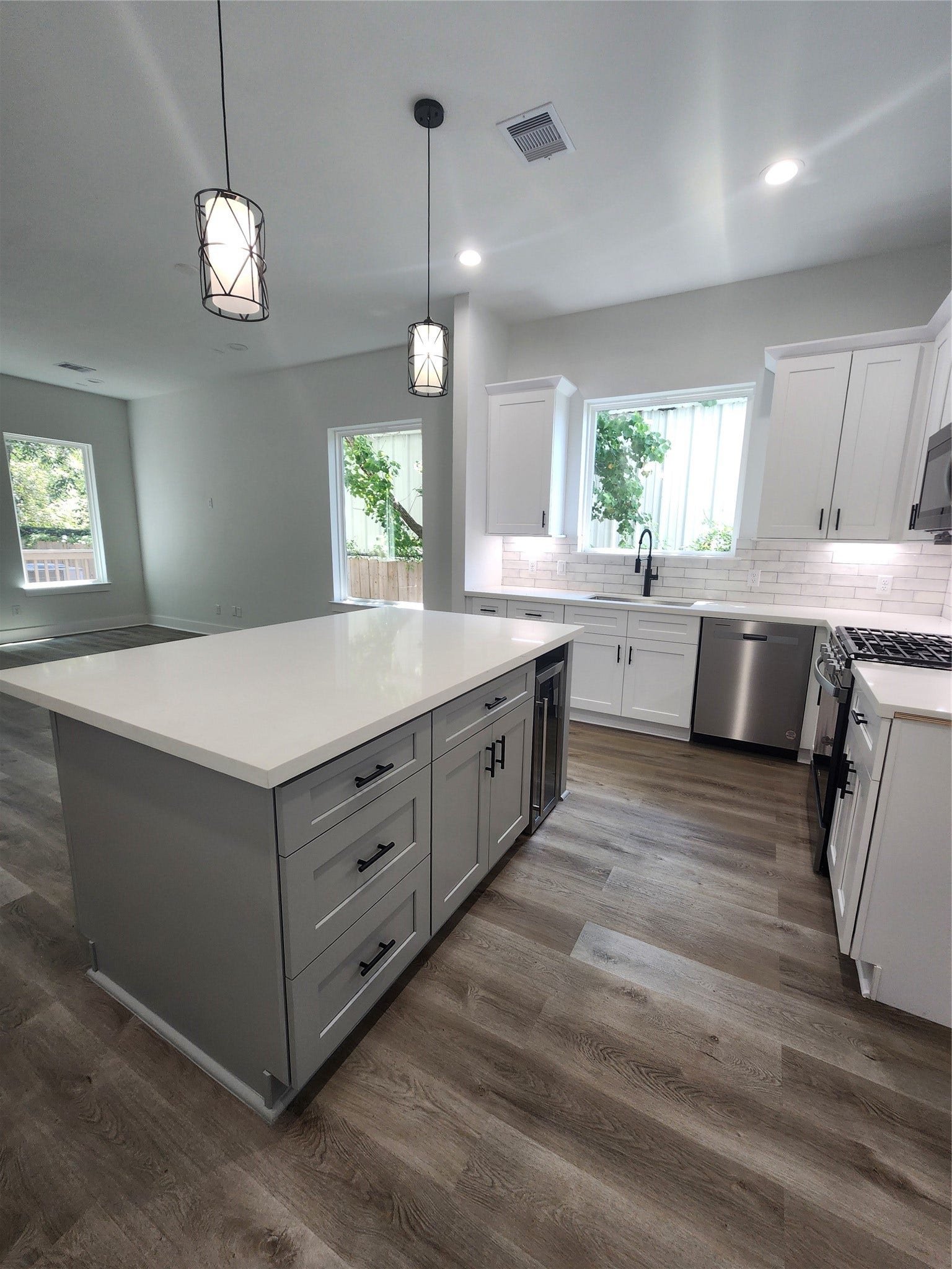 5518E CORTLANDT Street, Houston, TX 77076 Ample storage in the sleek kitchen island enhances functionality and style.
