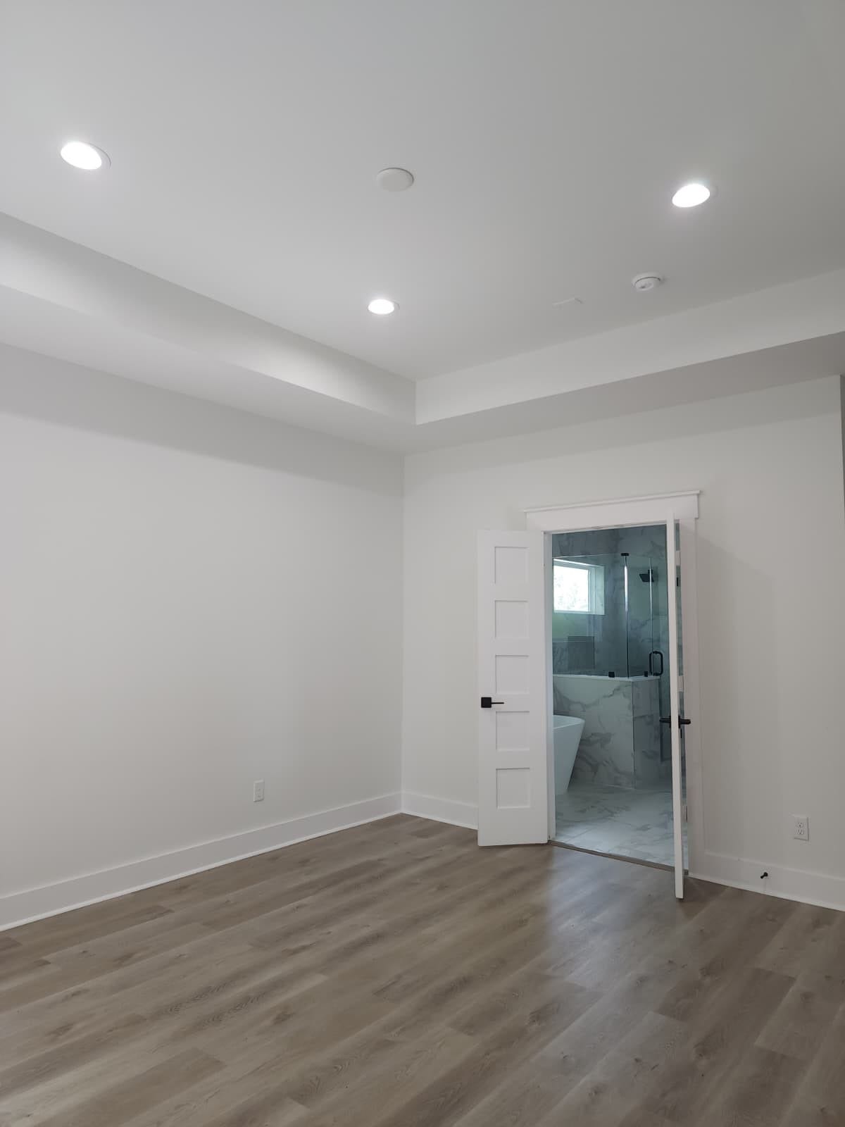 5518E CORTLANDT Street, Houston, TX 77076 Spacious primary bedroom with a raised ceiling and abundant natural light.