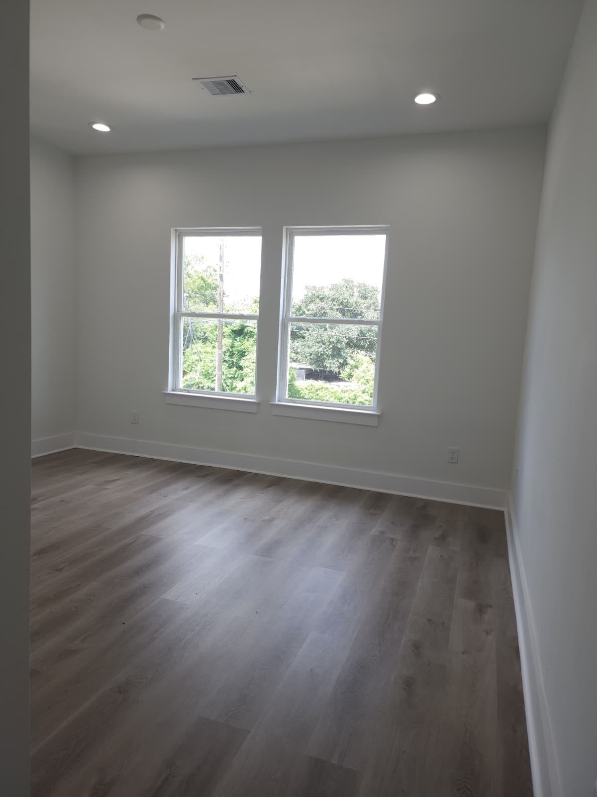 5518E CORTLANDT Street, Houston, TX 77076 Secondary bedroom #2 offers abundant natural light with its street-facing windows.