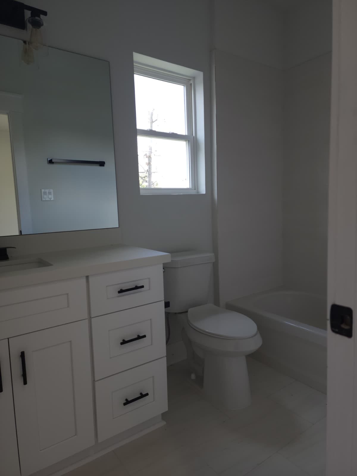 5518E CORTLANDT Street, Houston, TX 77076 Charming private bathroom featuring modern fixtures and a soothing color palette, perfect for relaxation and privacy.