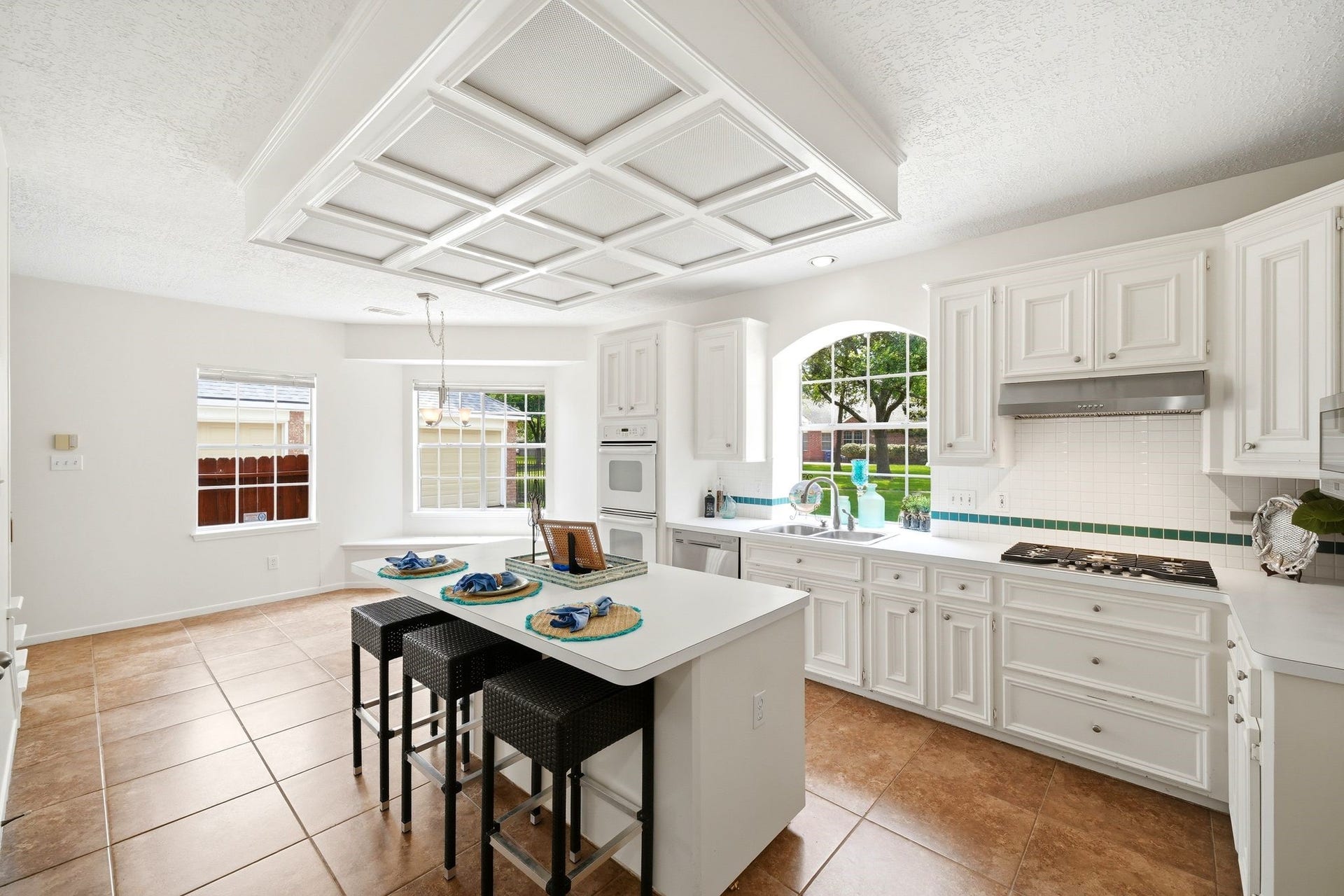 2216 Fairwater Park Drive, League City, TX 77573 Bright and inviting, this kitchen boasts sleek white appliances, a built-in gas cooktop, and a spacious pantry, perfect for culinary enthusiasts.