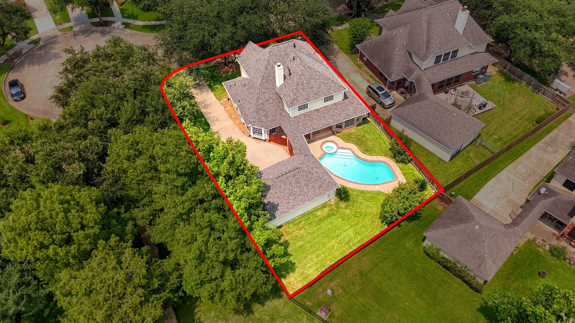 2216 Fairwater Park Drive, League City, TX 77573 Discover a spacious two-story home nestled in a quiet neighborhood, featuring a large backyard with a sparkling swimming pool and inviting patio, surrounded by lush greenery.